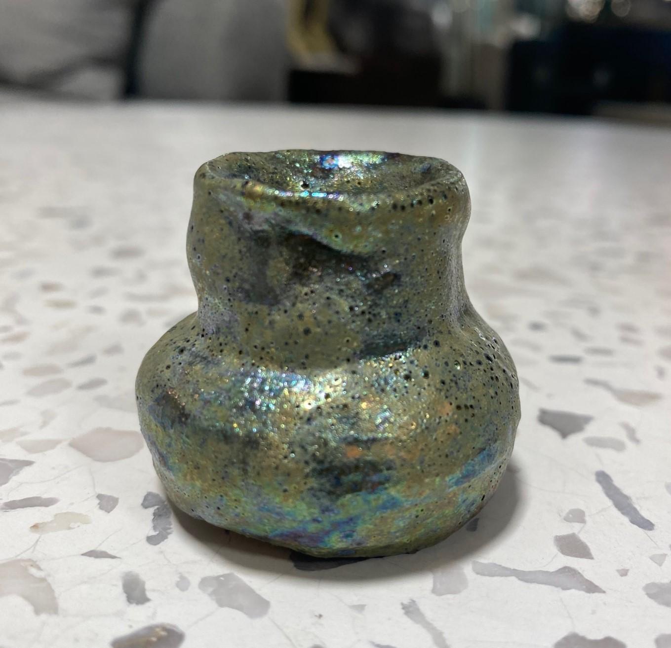 A wonderful, absolute gem of a piece by famed American California studio ceramist Beatrice Wood featuring her highly desired gorgeous iridescent luster volcanic (crater) lava glaze.  This miniature (mini) vase/vessel/pot may very possibly be the