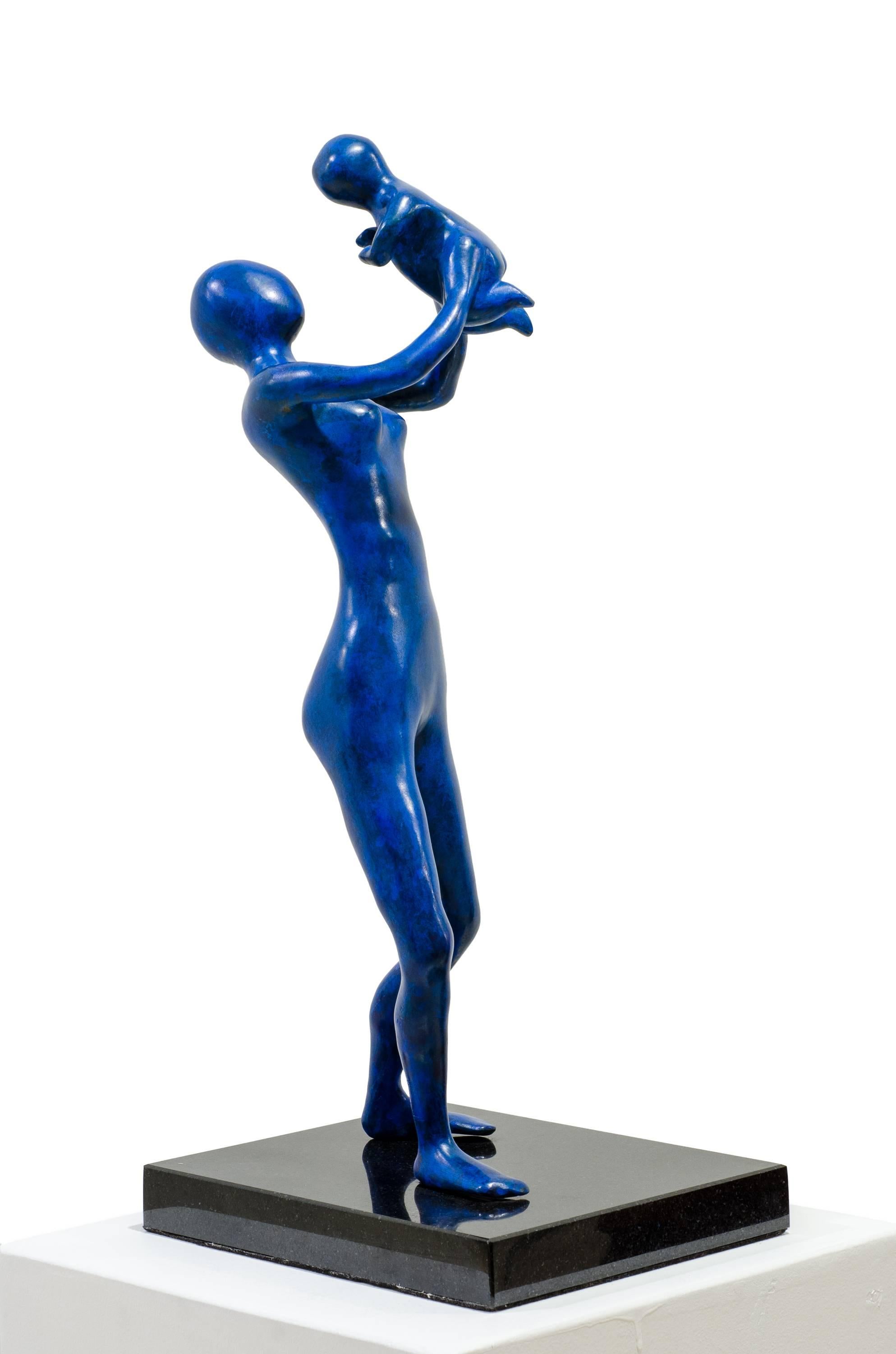 Mother in Blue. The mother proudly holds up her baby, enjoying the laughter For Sale 4