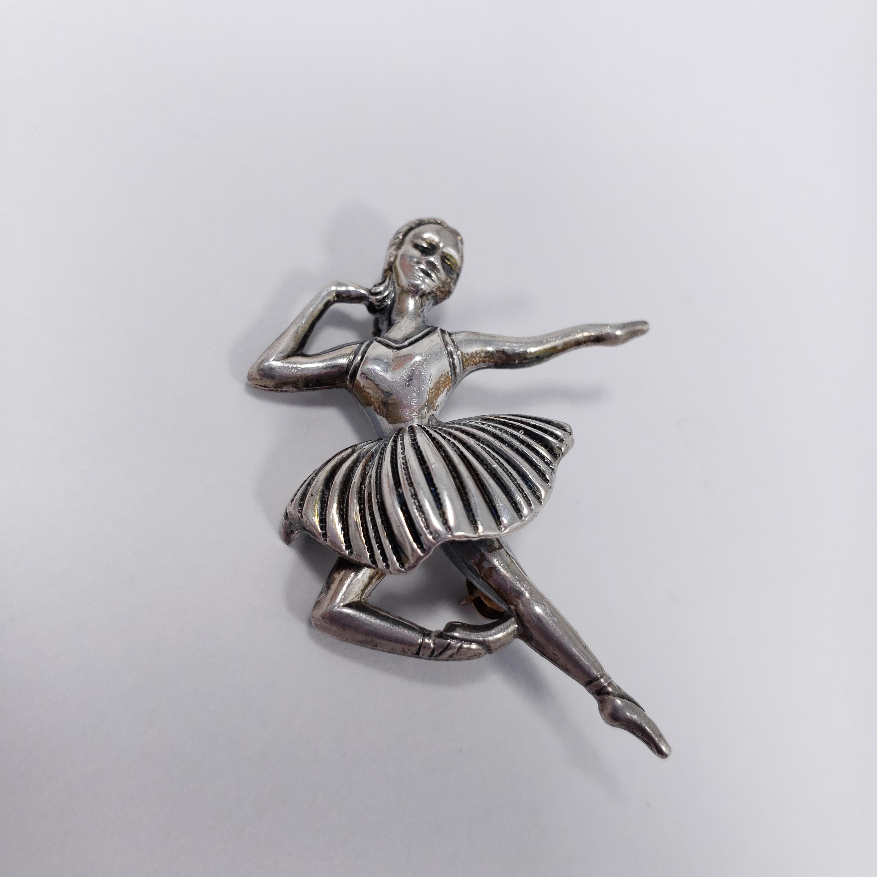 A dazzling vintage brooch, featuring a dancing ballerina in sterling silver. Excellent detail!

Hallmarks: Sterling