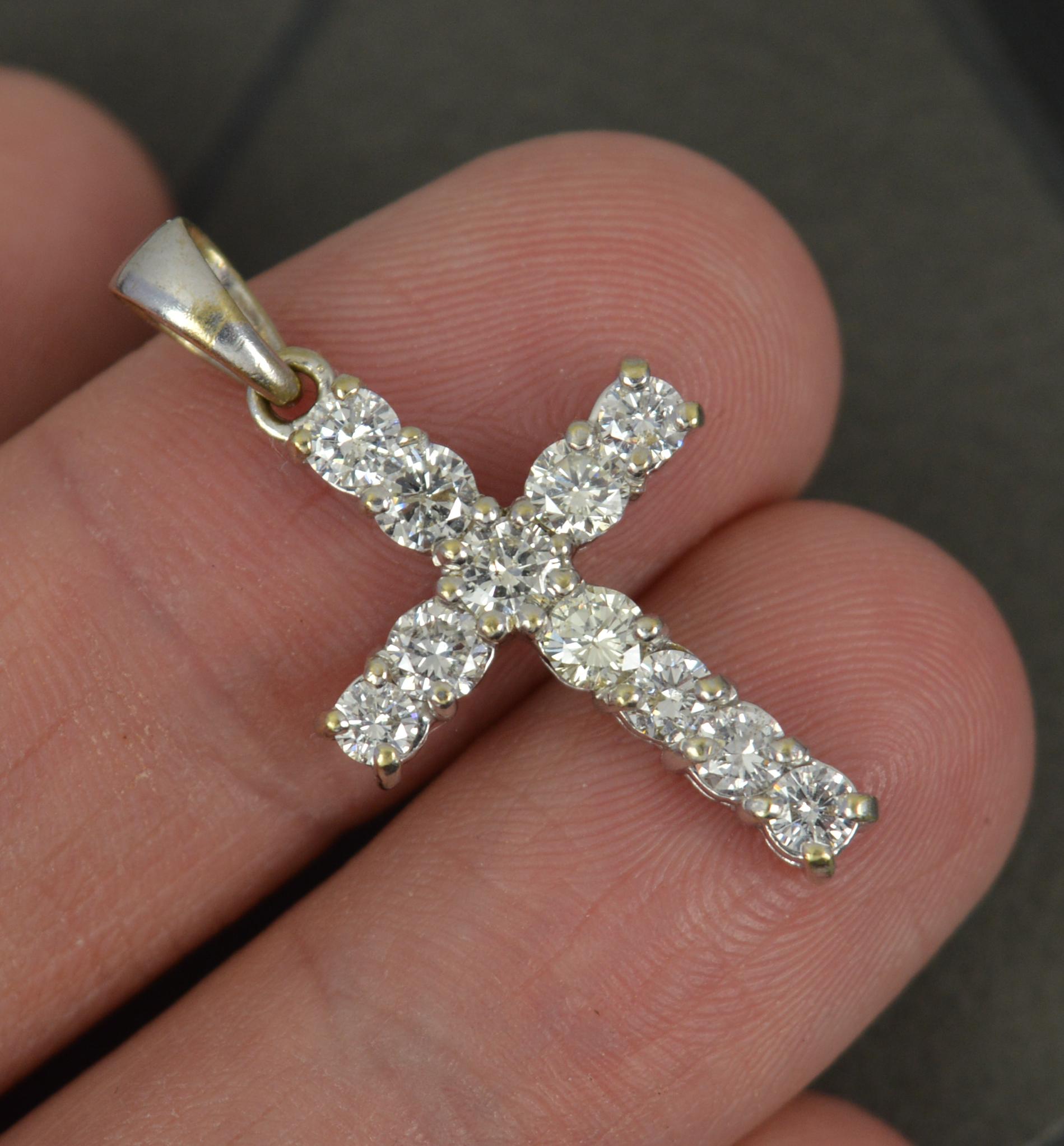 A superb contemporary diamond cross. 
Solid 18 carat white gold example.
Set with eleven round brilliant cut diamonds to total 1.00 carats. Bright, white and sparkly diamonds. All well matched, untreated.

CONDITION ; Excellent. Beautiful example.