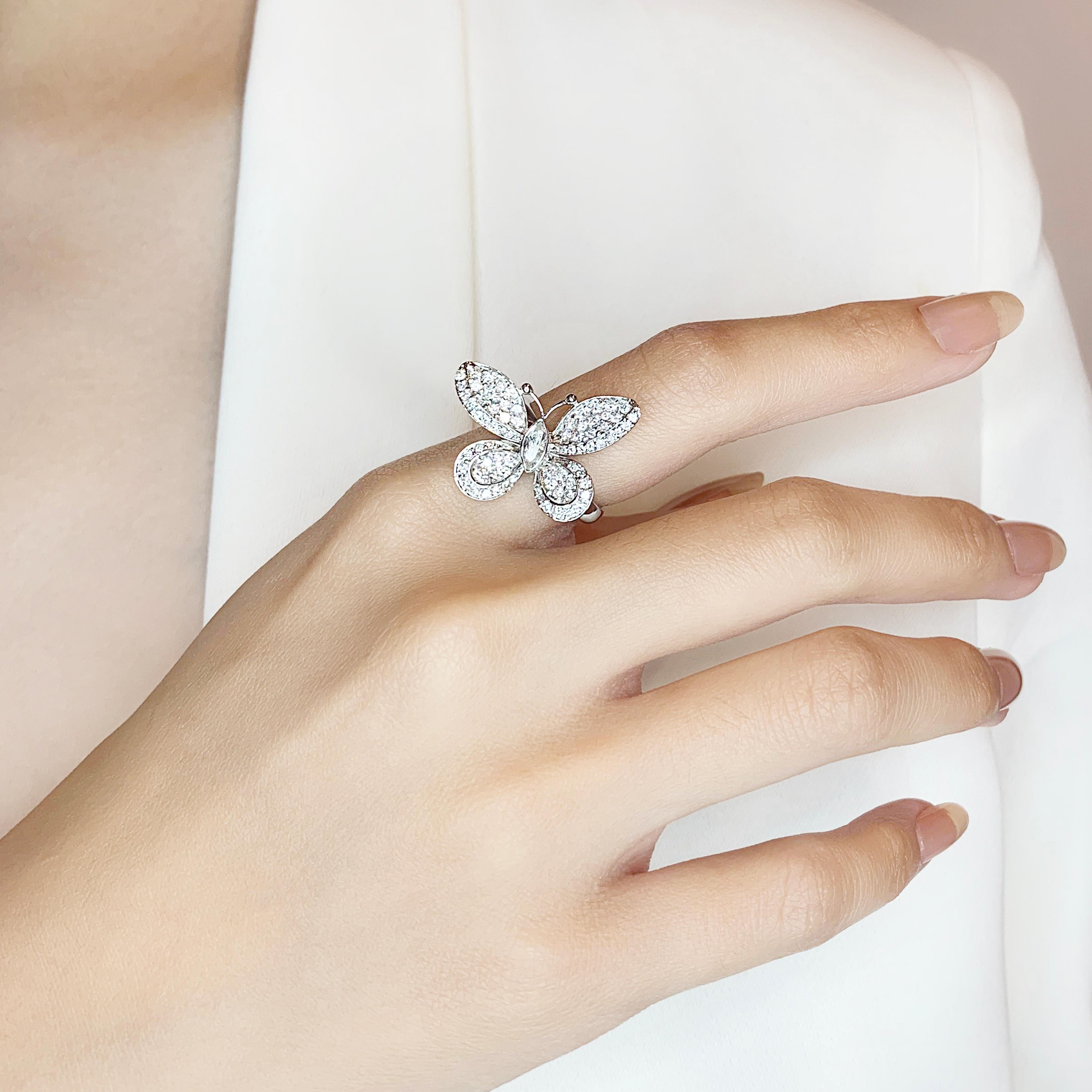 This charming butterfly design ring features a stunning marquise-shaped diamond as the main stone, weighing 0.12ct, set in 18K white gold. The main diamond boasts a G color grade and VS clarity grade, exuding brilliant sparkle and clarity. Enhancing