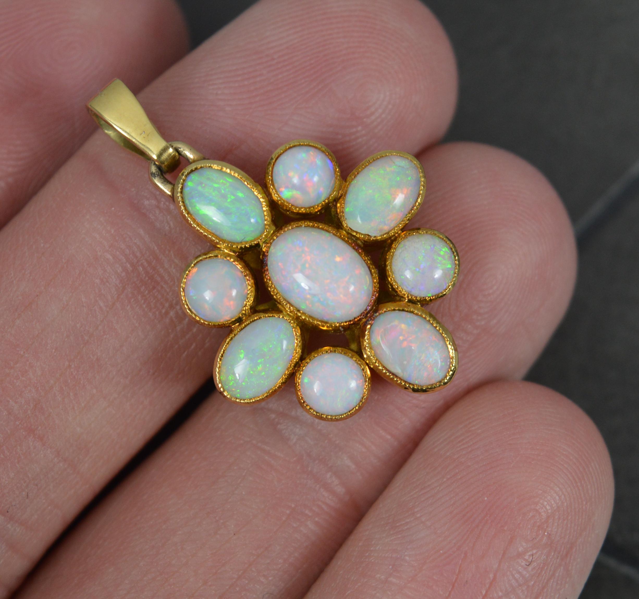 A superb statement pendant.
Solid 14 carat gold example.
Designed with many oval and round shaped natural opals. Full of colour. Finely set into grain bezel settings.

CONDITION ; Excellent. Beautiful example. Polished. Well set stones. Once small