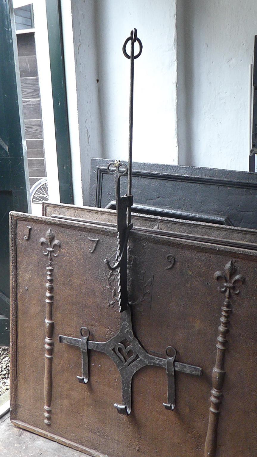 Beautiful 17th century French fireplace trammel made of wrought iron. 

The trammel was used for cooking to regulate the distance between the pots and the fire. The height is the length of the saw. The trammel is still functional.

We have a
