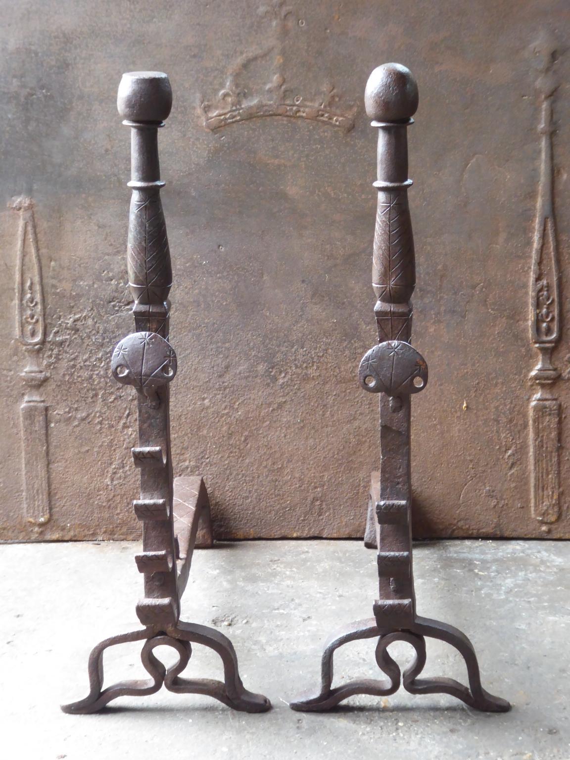 Beautiful 17th century French andirons made of wrought iron. The style of the andirons is Louis XIII and they are from that period. The andirons have spit hooks to grill food. They are in a good condition, despite their age.







 