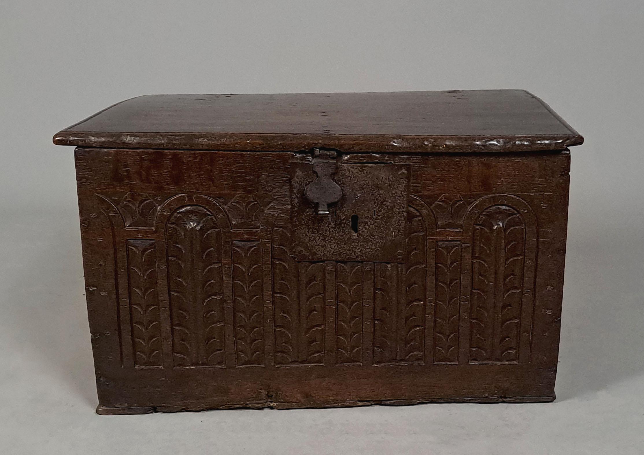 With a fabulous colour and natural deep patination, this wonderful very small oak chest has retained its original timbers throughout and original lock plate and hasp.   

The front and side boards carved with palm leaves in arched carved and punched