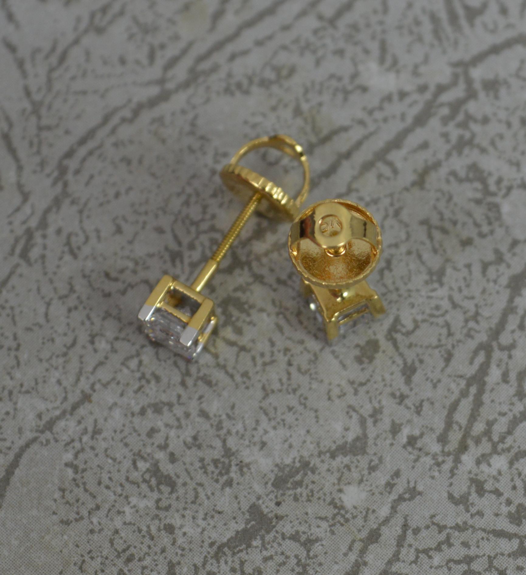 A superb pair of diamond single stud earrings.
Solid 18 carat yellow gold settings and backs.
Pierced, screw backs.
Each set with a natural, princess cut diamond in four claw setting. 1.00 carat total weight. Estimated vs clarity, g-h