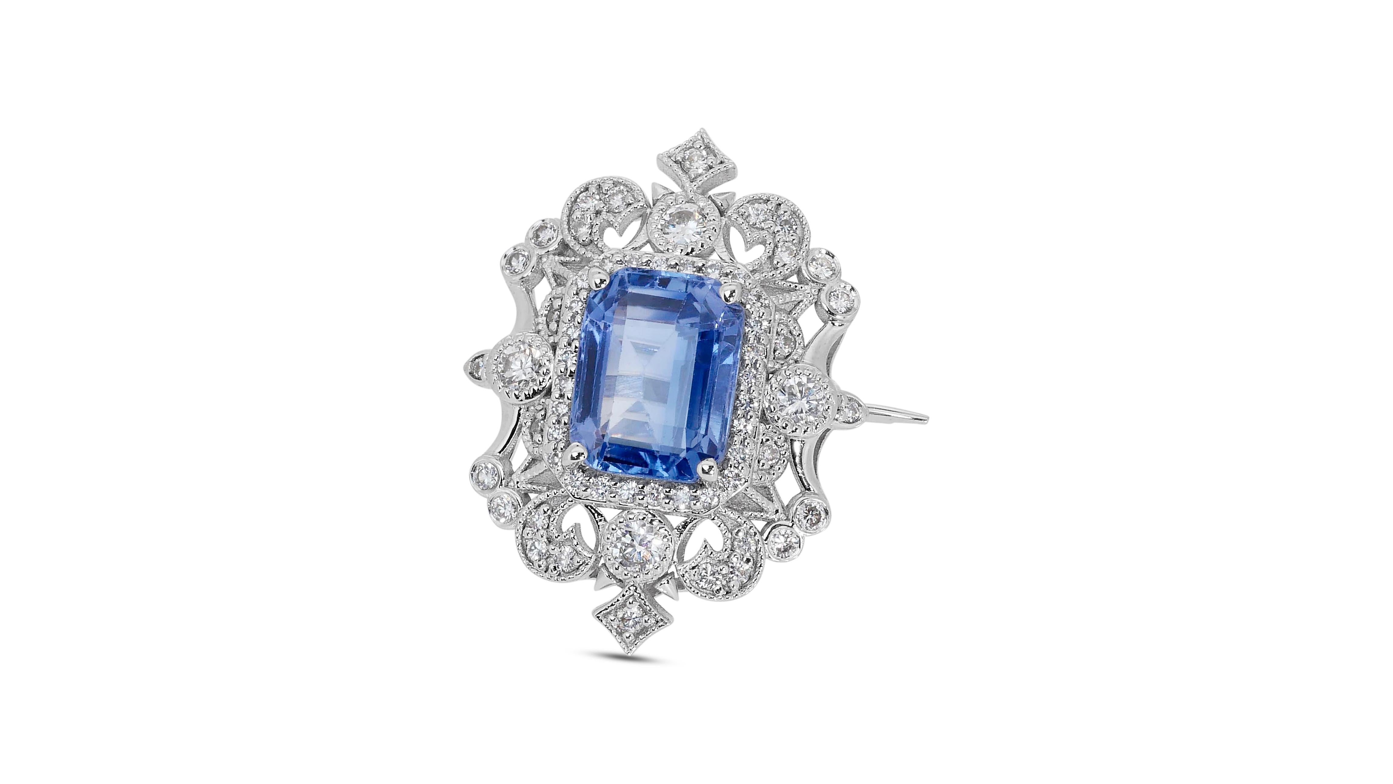 A gorgeous brooch with a dazzling 4.99 carat octagonal natural sapphire. It has 0.80 carats of side diamonds which add more to its elegance. The jewelry is made of 18k White Gold with a high-quality polish. It comes with a GIA certificate and a nice