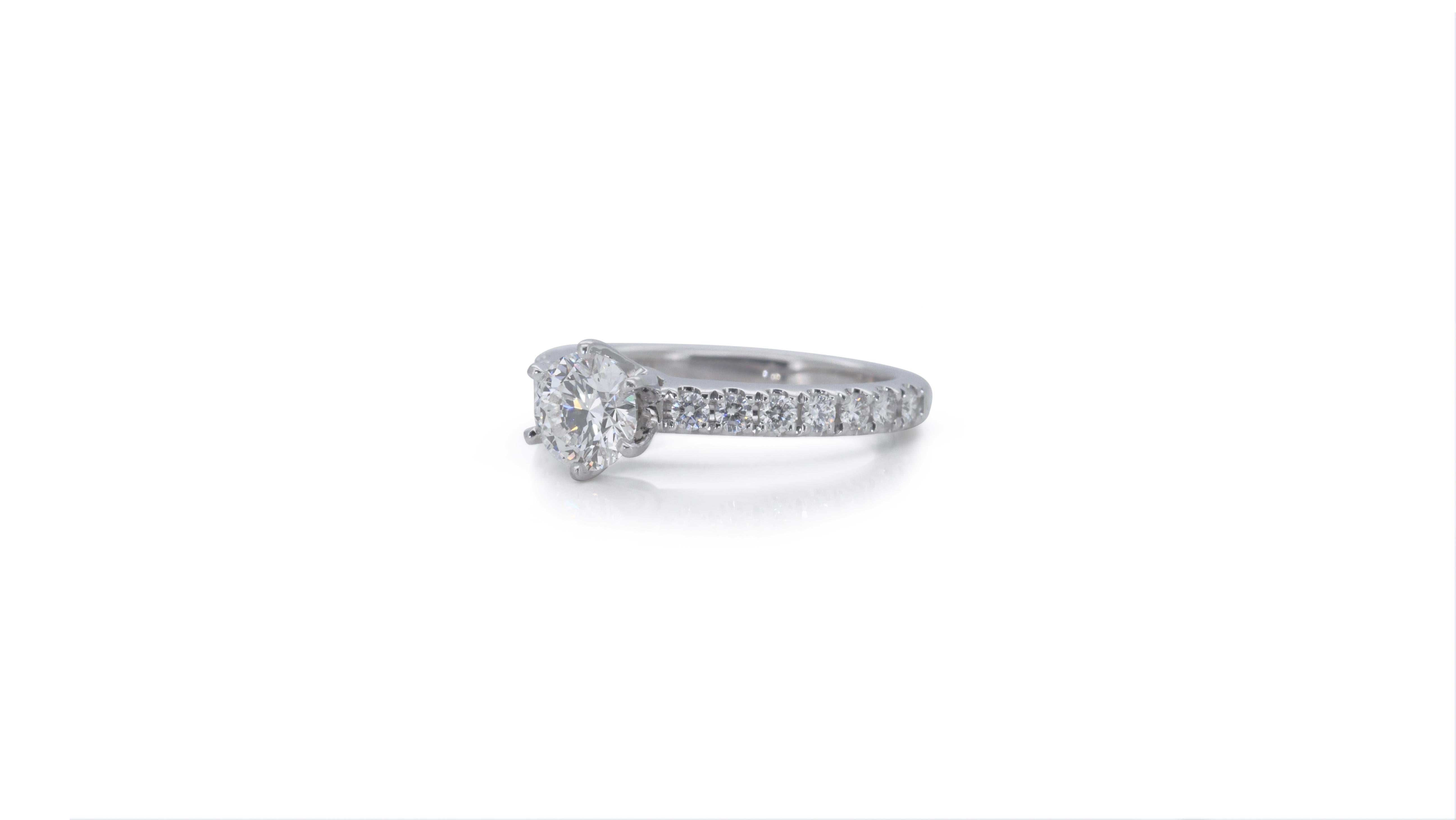 A beautiful pave ring with a dazzling 0.52 carat round brilliant natural diamond. It has 0.21 carat of side diamonds which add more to its elegance. The jewelry is made of 18k White Gold with a high quality polish. It comes with a fancy jewelry