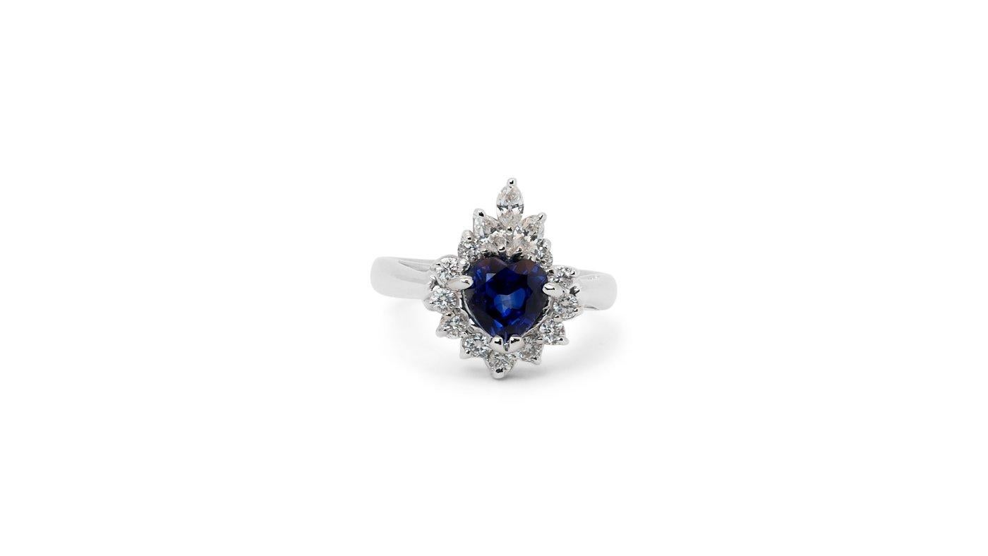 A gorgeous cluster ring with a dazzling 1 carat heart mixed shape natural sapphire. It has 0.34 carat of side diamonds which add more to its elegance. The jewelry is made of 18K White Gold with a high quality polish. It comes with IGI certificate