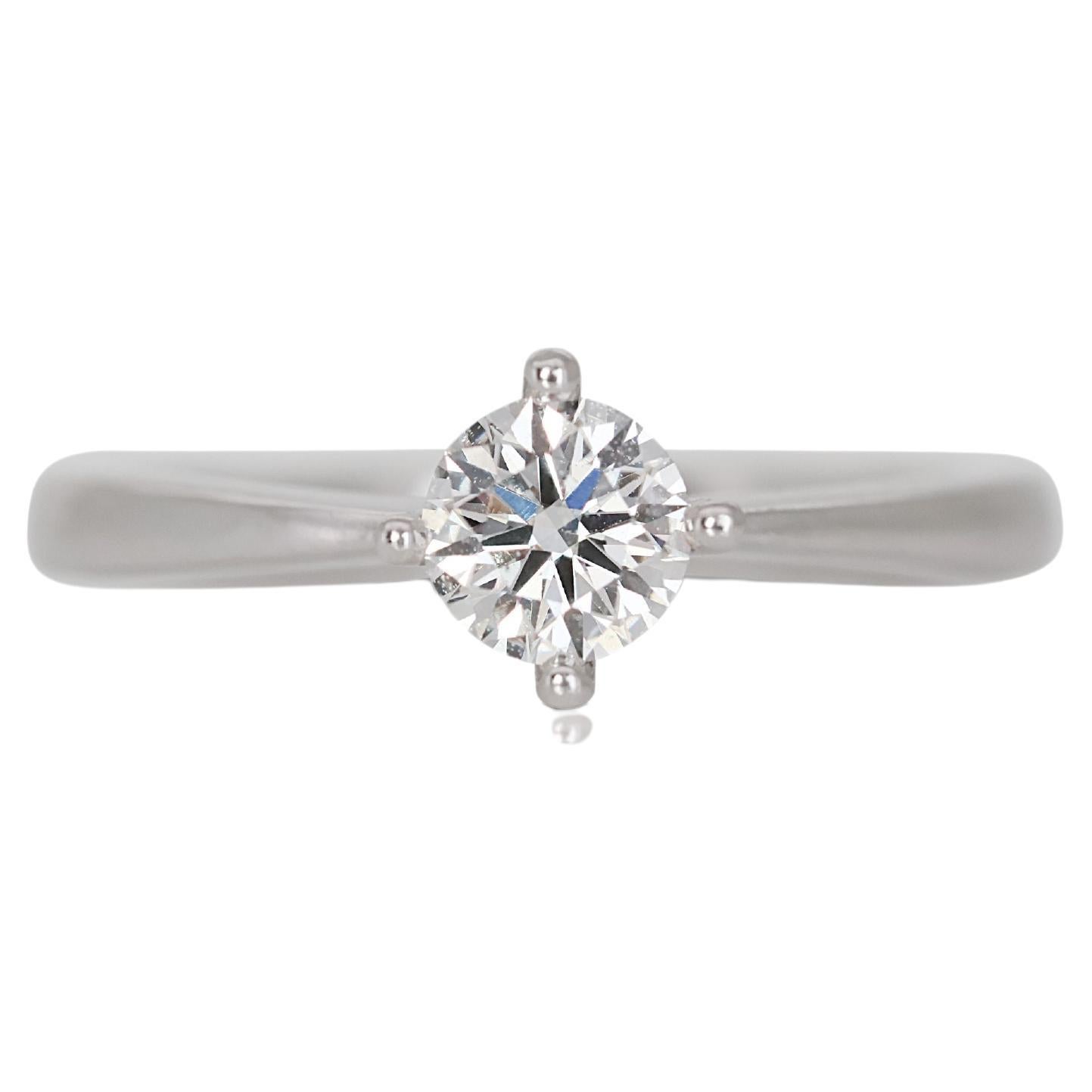 Beautiful 0.32ct Solitaire Diamond Ring in 18K White Gold

The focal point of this ring is a remarkable solitaire diamond, weighing 0.32 carats, known for its exquisite clarity and dazzling brilliance. This diamond is thoughtfully set in an elegant