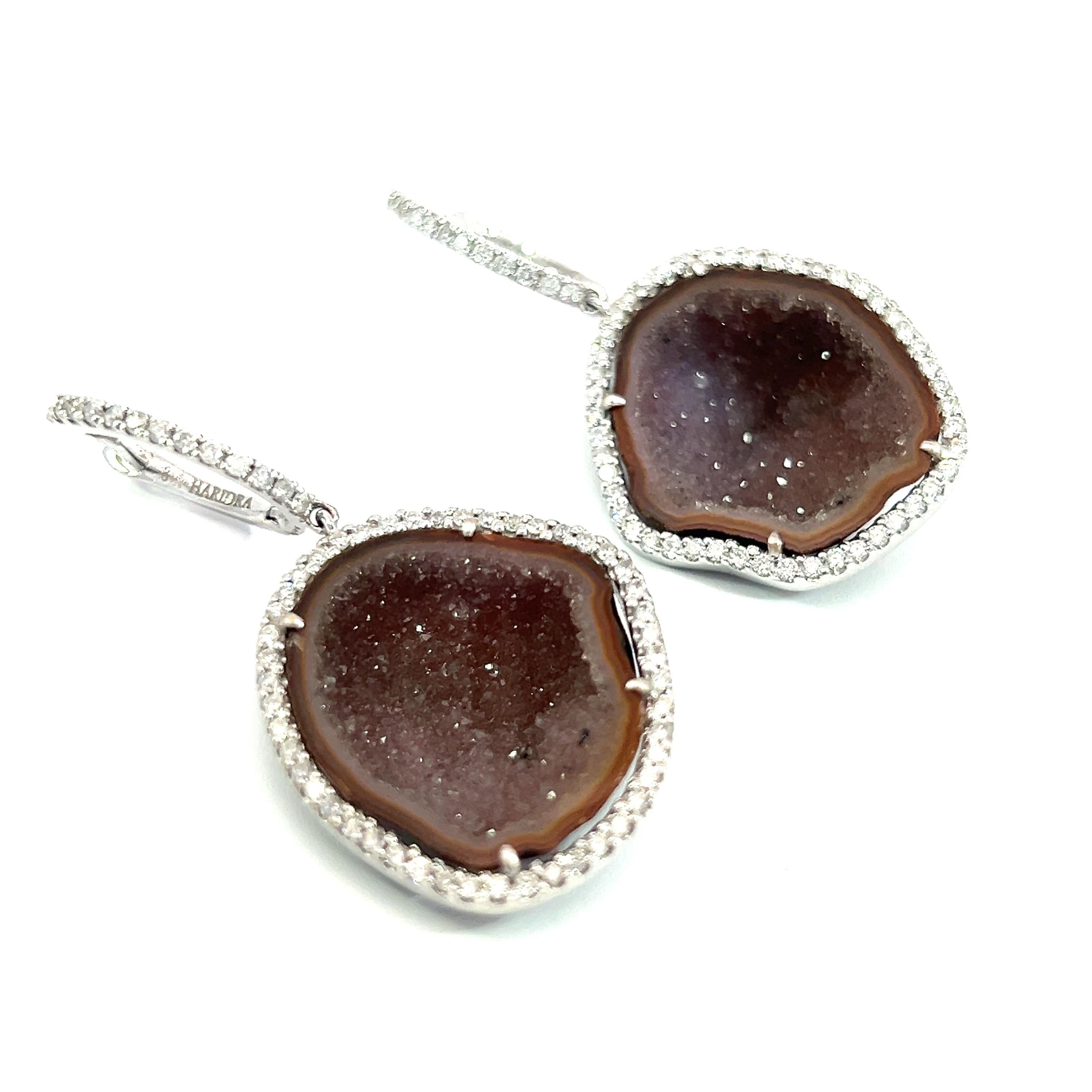 These stunning 16.71-Carat Druzy quartz and 0.95-carat diamonds earrings feature a unique blend of natural beauty and sophisticated design. The raw, earthy texture of the geodes is beautifully framed by sparkling crystals and earrings are