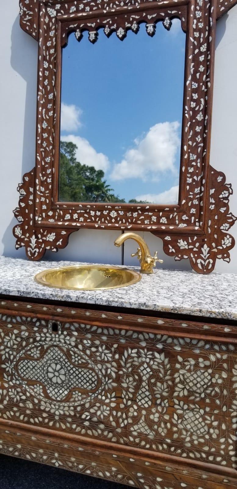 Beautiful 19th century Middle Eastern mother of pearl vanity and mirror. Old Syrian wedding chest Re- purposed into a sink vanity and mirror set. The chest is walnut and mother of pearl with a beautiful matching mother of pearl mirror. Measures: