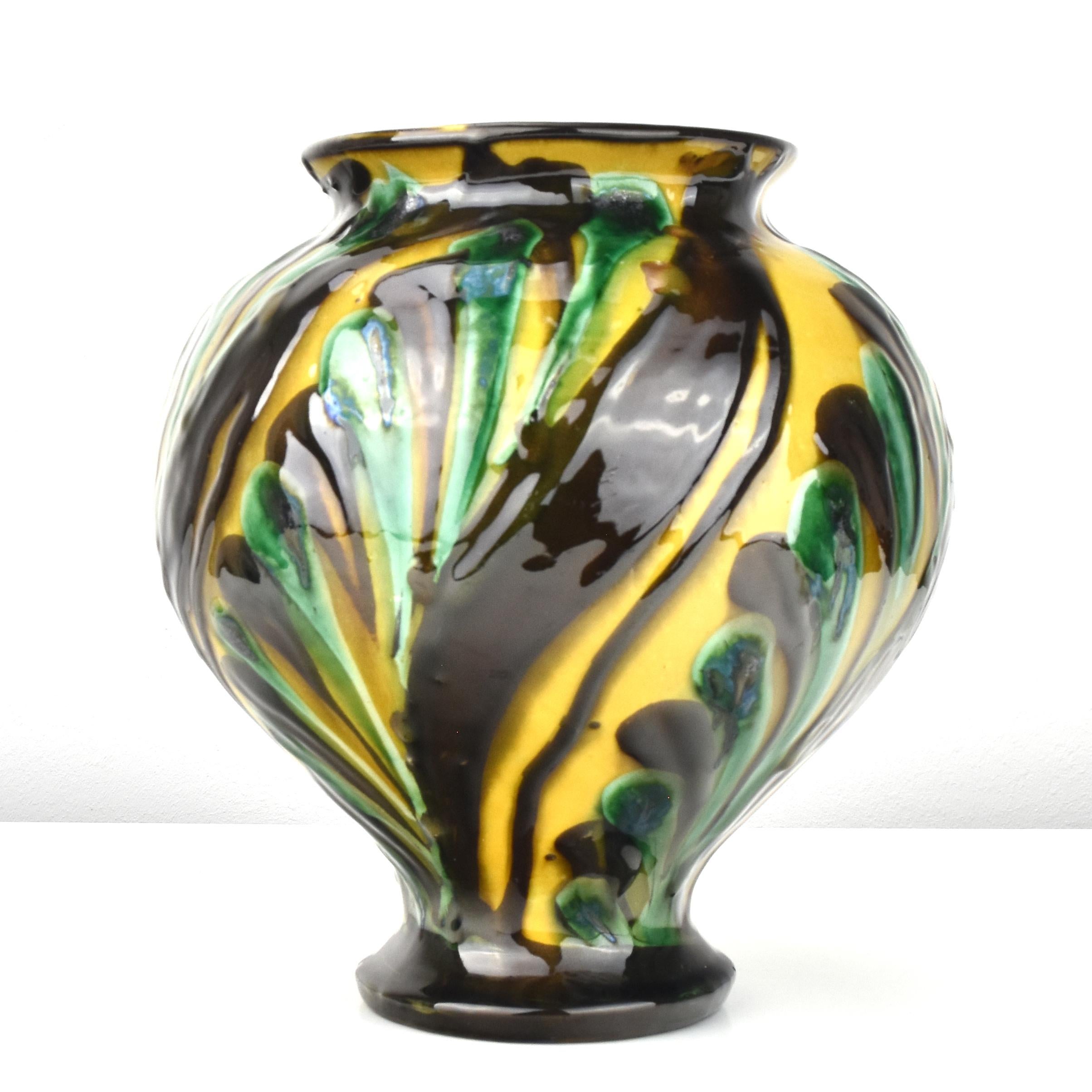  A baluster shaped vase with high glossy finish made in the 1920s by the famous Danish potterer Herman Kähler.
The glazes shows a beautiful surrounding leaf-shaped decoration and it displays stunning light reflections.
