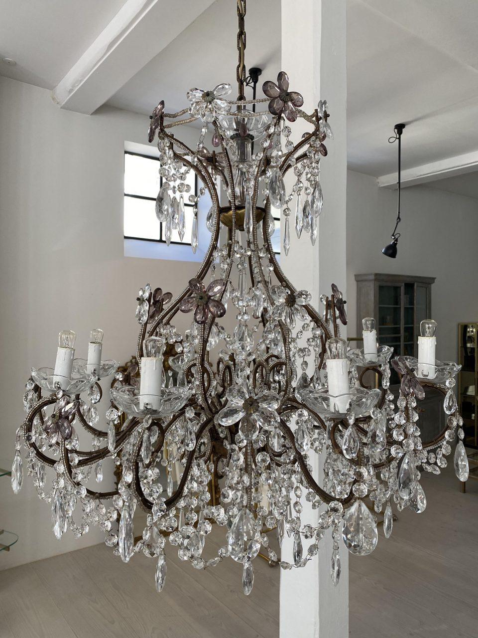 Elegant very beautiful French chandelier from circa 1920s, and typical of one found in French chateaux and mansions. True opulence of clear crystal and beautiful facet cut prisms of various sizes as well as fine smoky and clear floral rosettes,