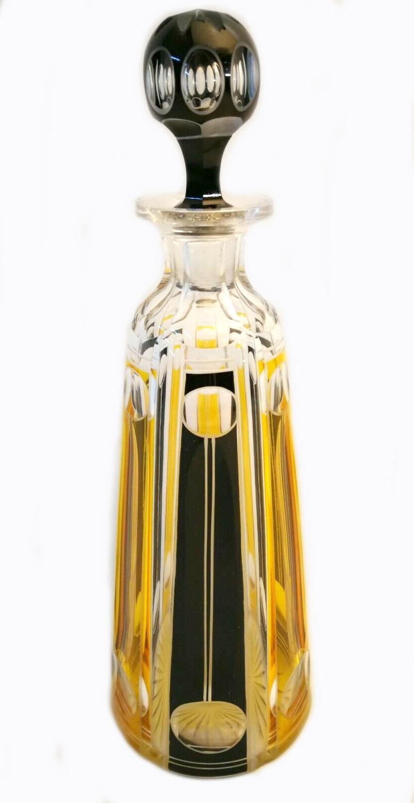 This is a wonderful opportunity to acquire a very stylish and collectable Art Deco cut glass decanter set by Karl Palda. The set comprises a tall decanter with a faceted stopper which has an over-lay in black and yellow enamel. The six accompanying
