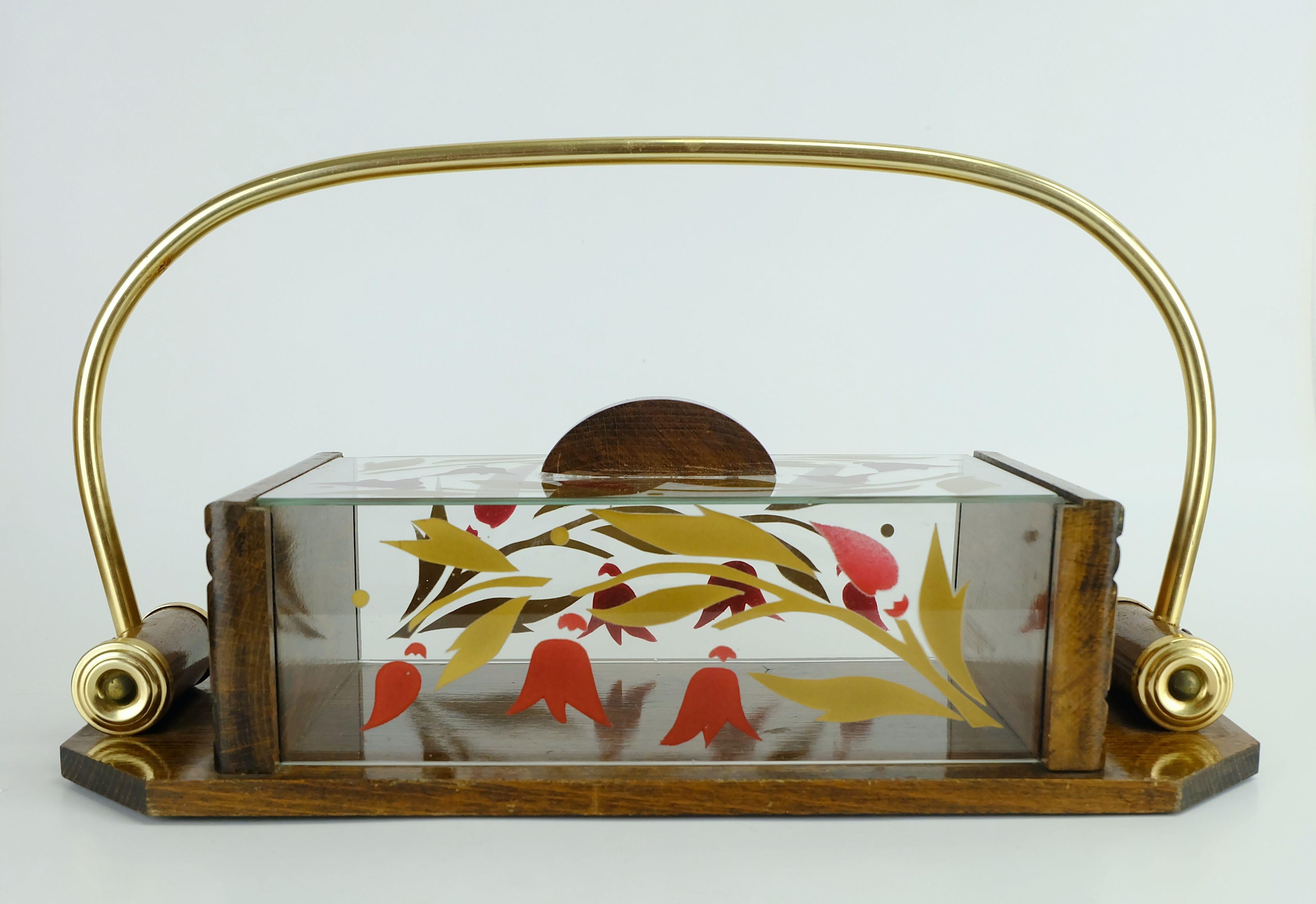 Very beautiful french 1930s cookie jar. Made of solid wood, glass and brass. With painted floral ornaments on the glass parts.

Dimensions: Length 12 1/4