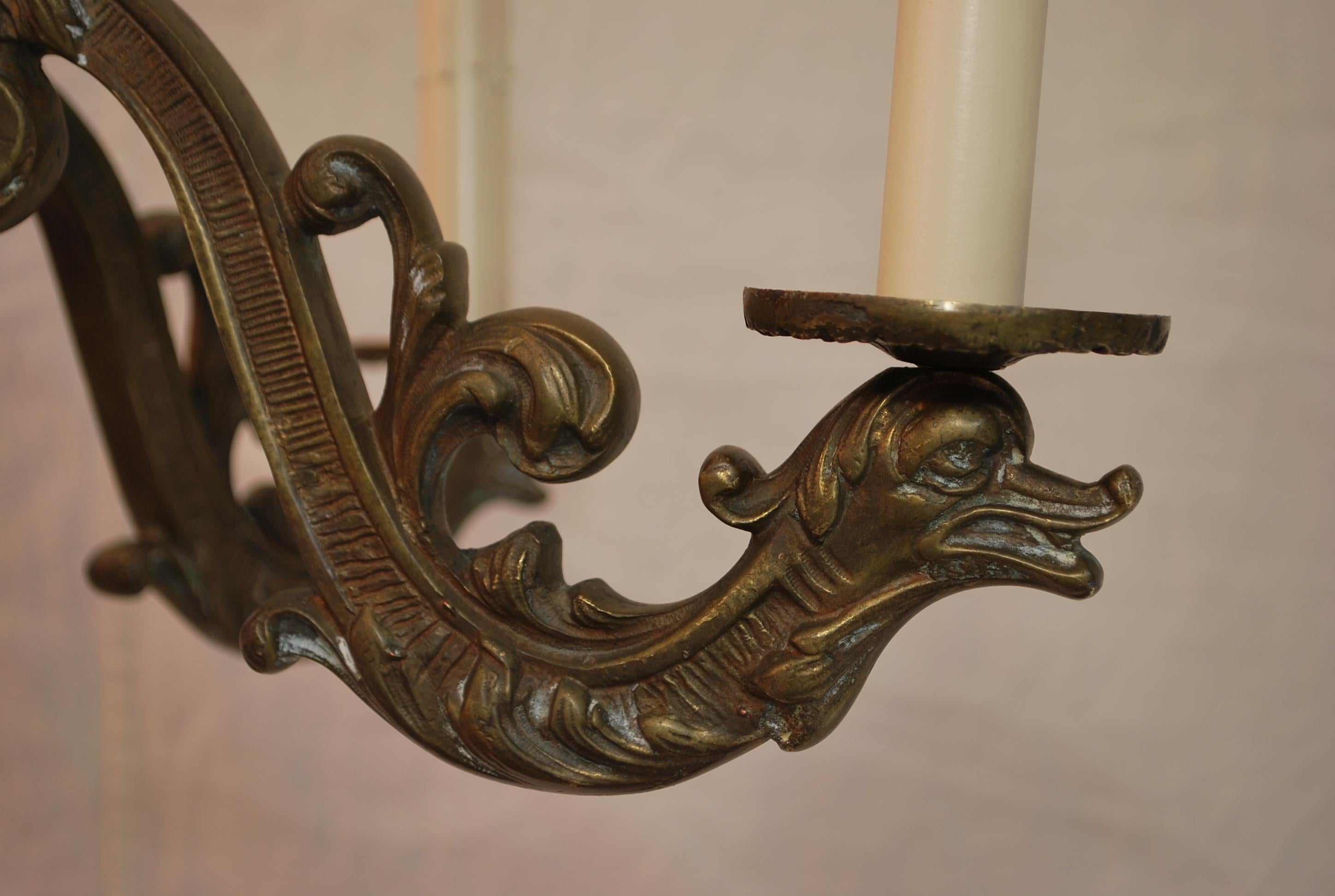 A beautiful  french solid bronze chandelier, it is decorated  with sea creatures, PLEASE REMEMBER, ON THE PICTURE IT LOOK LIKE THEY IS AN ARM THAT IS MORE REDDISH, THE CHANDELIER IS ALL THE SAME COLOR, IT IS JUST THE FLASH OF THE CAMERA MADE ONE ARM