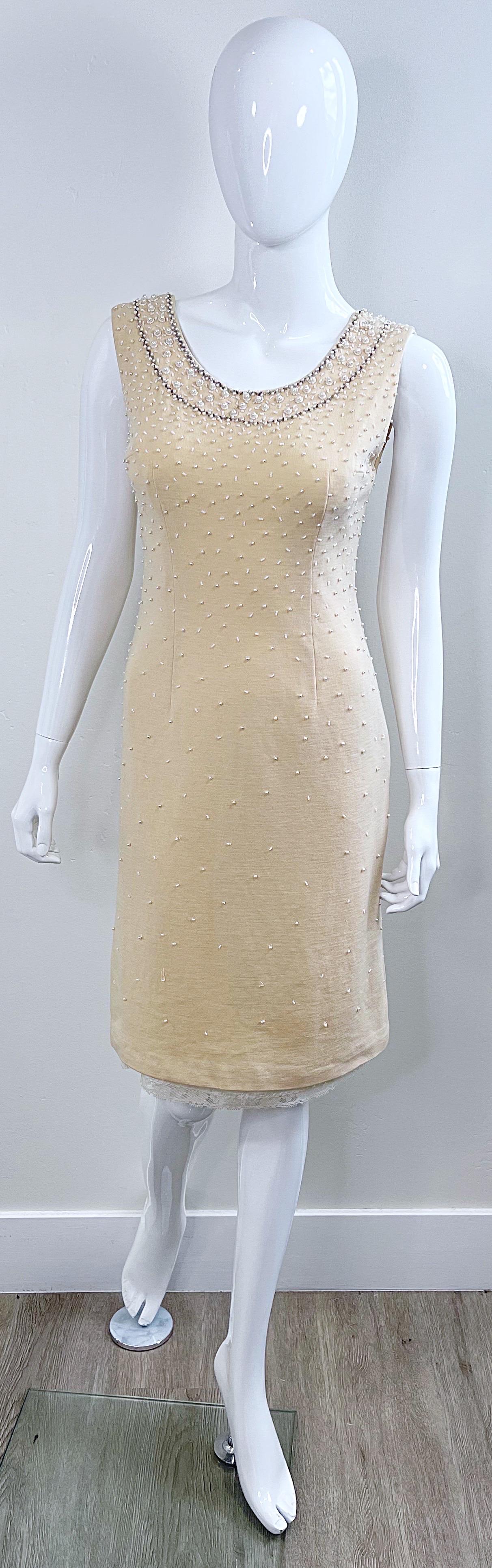 Beautiful late 1950s ivory / off-white lightweight wool beaded bombshell dress ! Features a silk lace slip that peek through at the hem. Hidden metal zipper up the back with hook-and-eye closure. Wonderful construction, with so much attention to