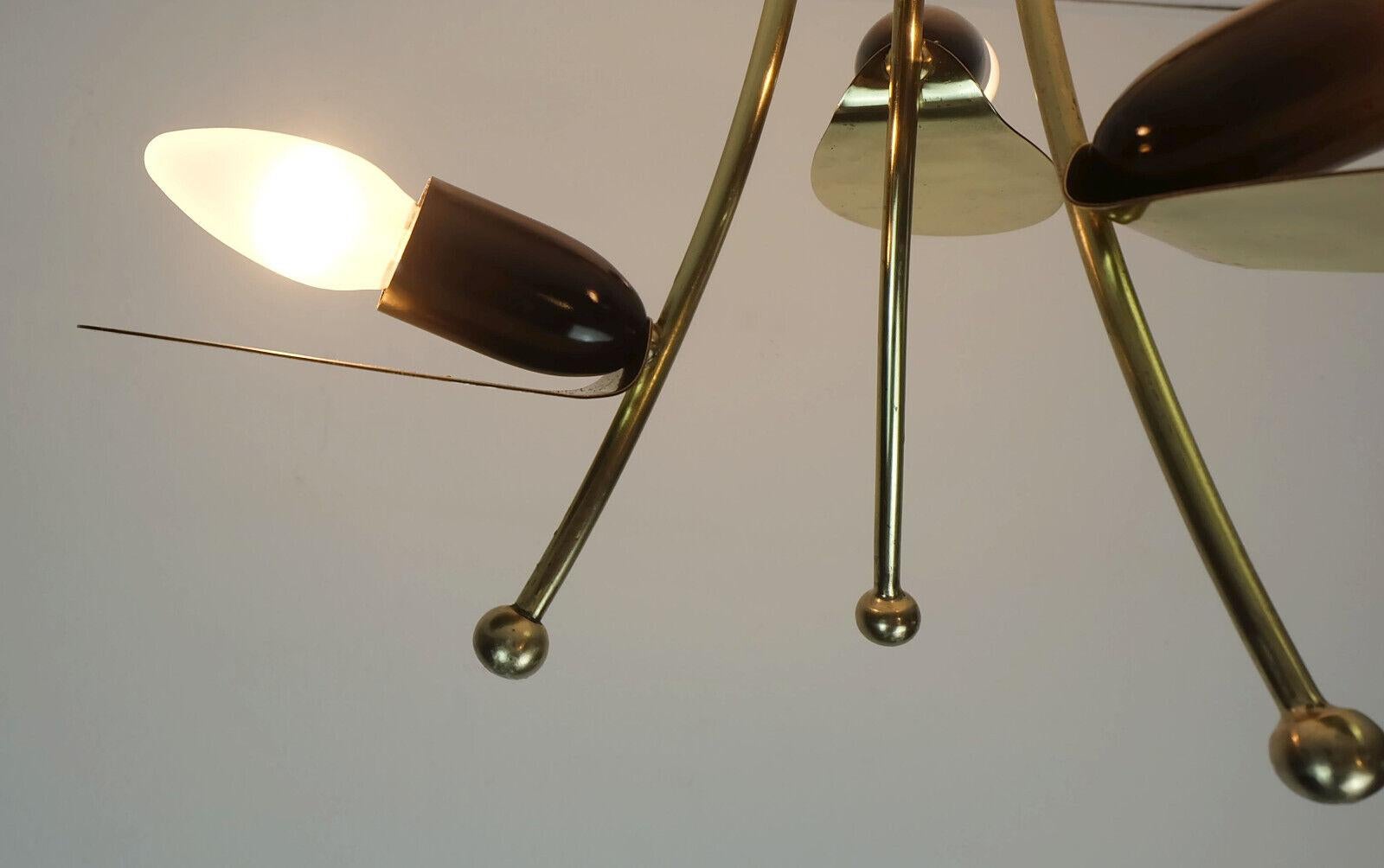 Very beautiful 1950s 3-light ceiling lamp. Made of polished brass and black and white lacquered metal. For light bulbs with E14 thread. 

Dimensions in cm:
Length 33 cm, diameter 35 cm.
 
Dimensions in inches: 
Length 12.99