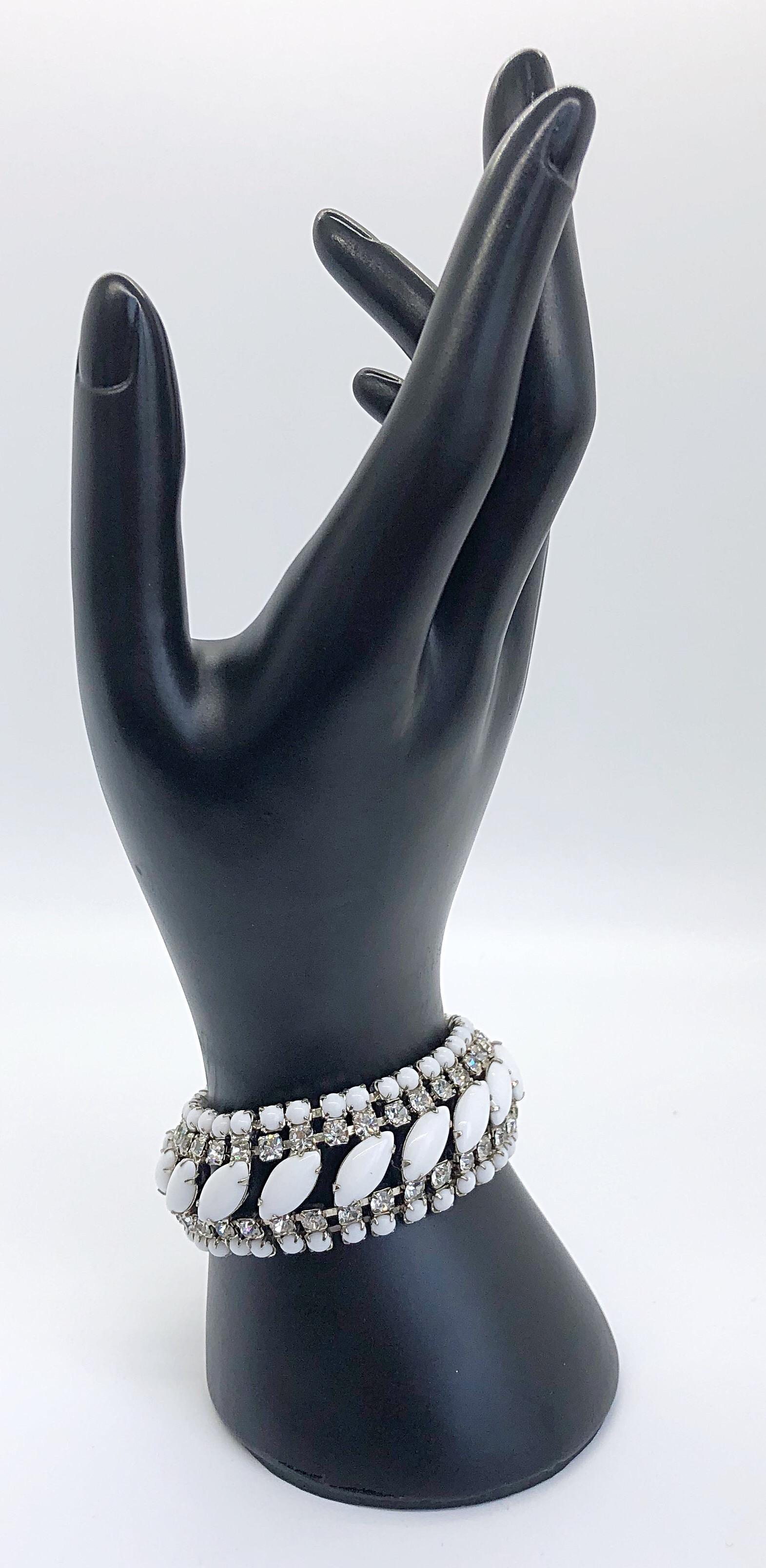 Beautiful vintage 60s rhinestone, white and silver bracelet! Delicate marquise ( navette ) shaped white opaque stones set upon clear sparkly rhinestones. Matching white opaque balls line the rhinestones. Silver link closure. Can easily be dressed up