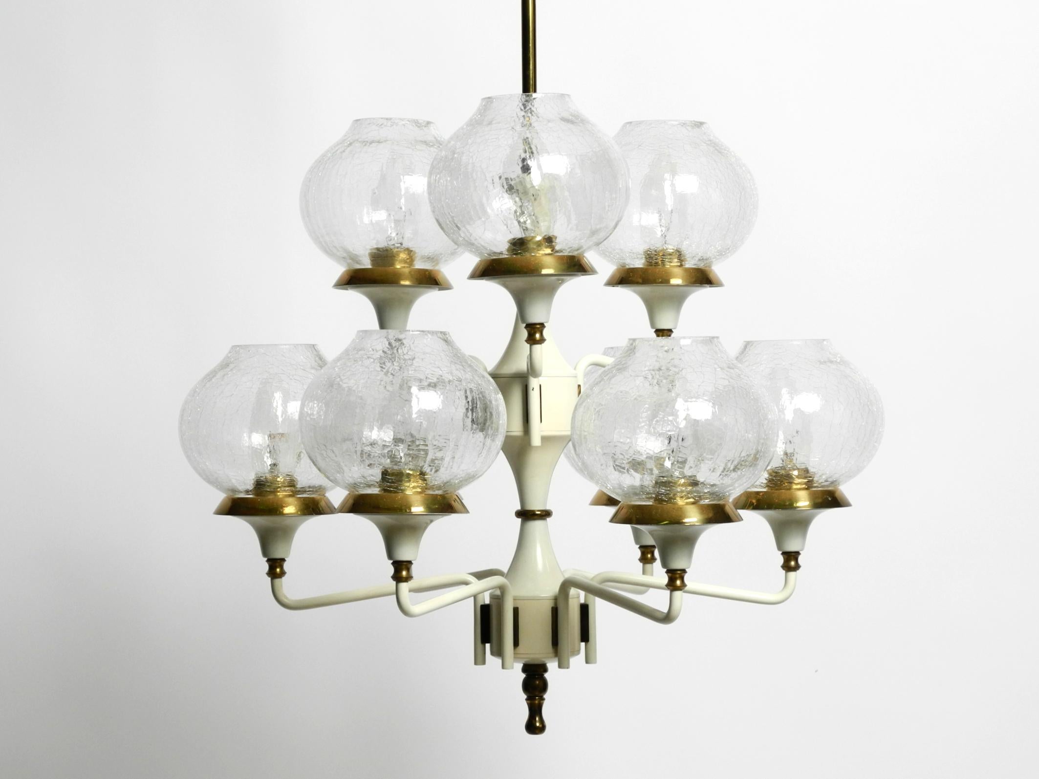 Beautiful 1960s metal and brass ceiling lamp with 9 arms.
Designed by Hans Agne Jakobsson. Manufacturer is Markaryd. Made in Sweden.
The frame is made of metal painted in white. The brackets, rod and canopy are made of brass.
Elegant design. Very