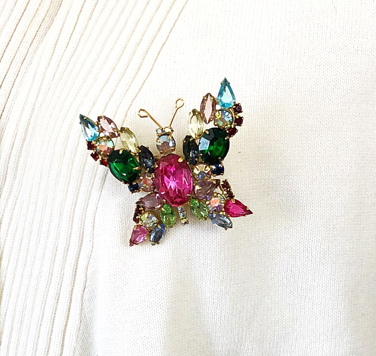 Beautiful early 1960s large butterfly rhinestone brooch / pin ! Features vibrant colored rhinestones in various shades of pink and fuchsia, green, blue, red, yellow and clear throughout. Gold antennas. Can really add just the right amount of pop to