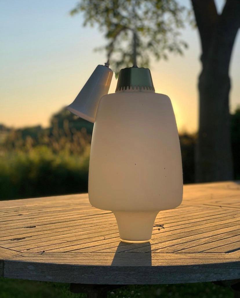 Pendant in opaline glass with brass on top. 
We don´t know who has made this beautiful pendant, but it is old - from the 1960s and problably from Denmark or Sweden, where there were designed so many nice lamps in the period (Bent Karlby, Jo