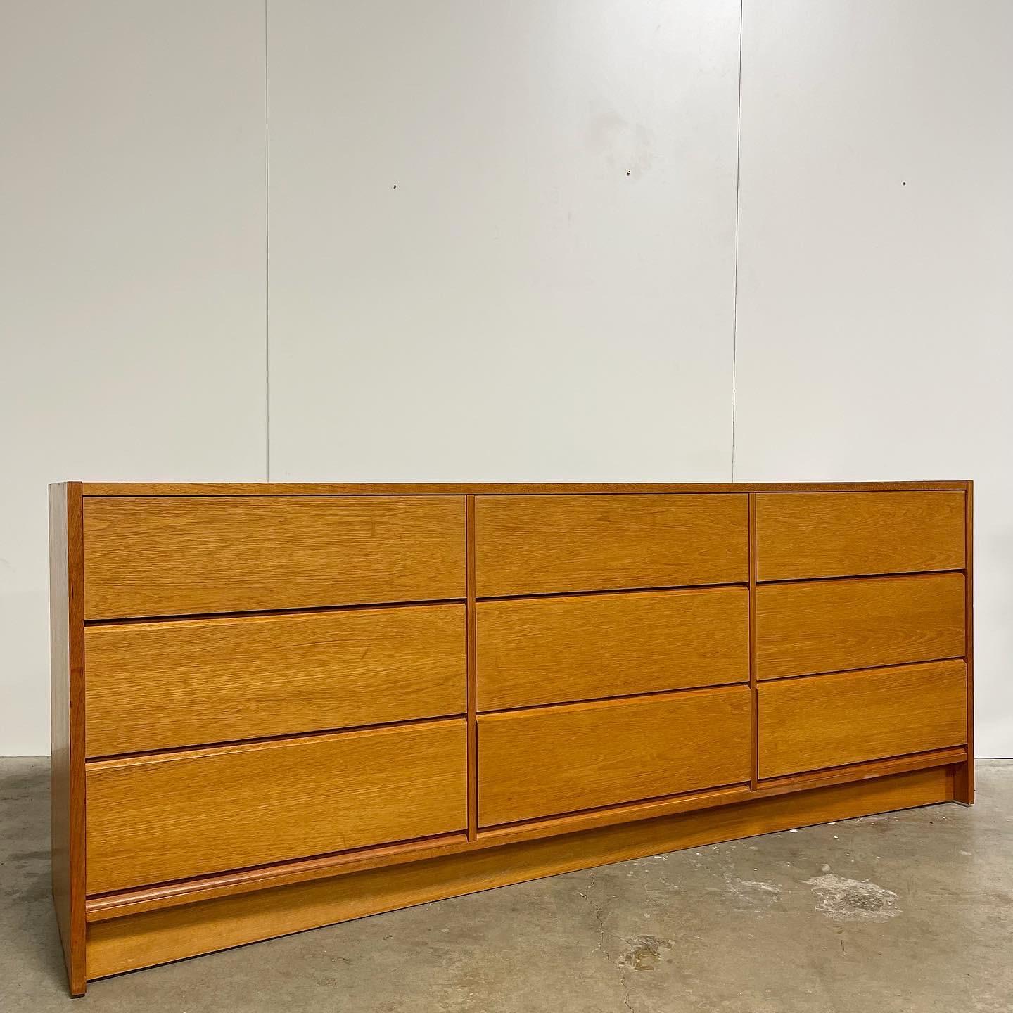Beautiful ‘70’s Danish 9 drawer lowboy. All drawers slide with ease on wooden side tracks. Sitting on a sleek plinth base. Teak wood veneer in good shape that pops in the sunlight! left side has some small veneer damage towards the bottom. Nothing