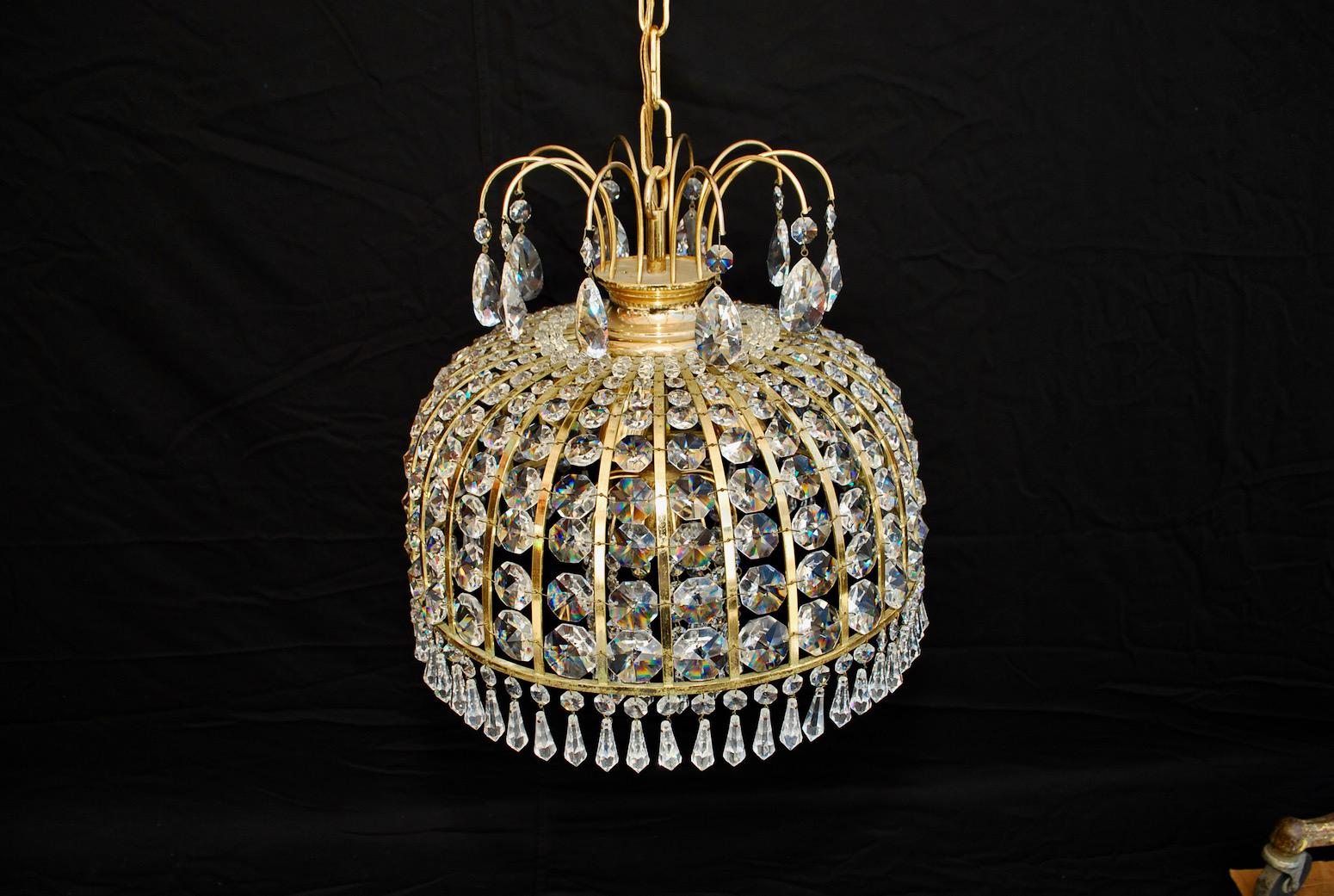 A beautiful and sparkles small crystal and brass chandelier.