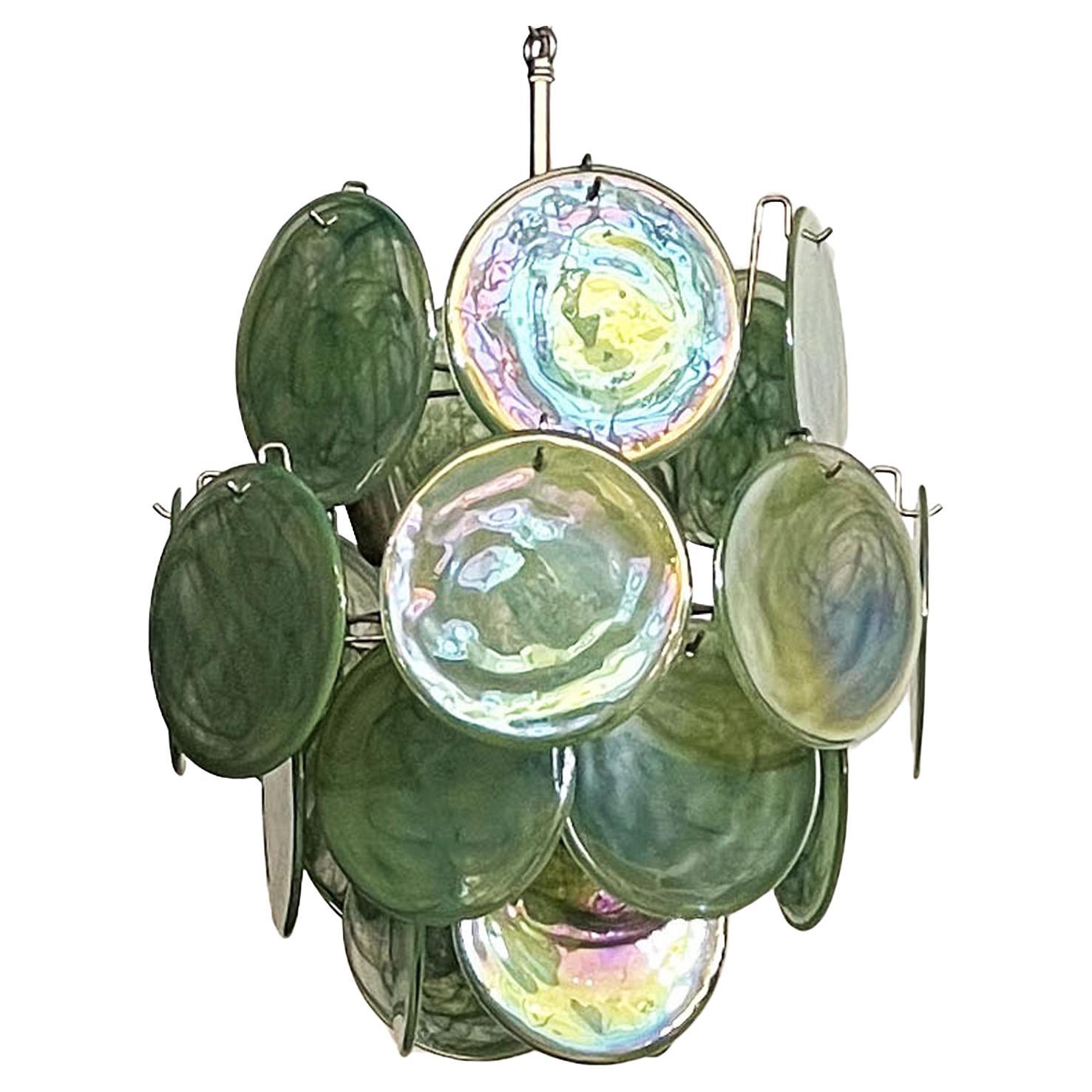 Vintage Italian Murano chandelier in Vistosi style. The chandelier has 24 fantastic iridescent alabaster green discs in a nickel metal frame.
Period: late XX century
Dimensions:41,30 inches (105 cm) height with chain; 20,50 inches (52 cm) height