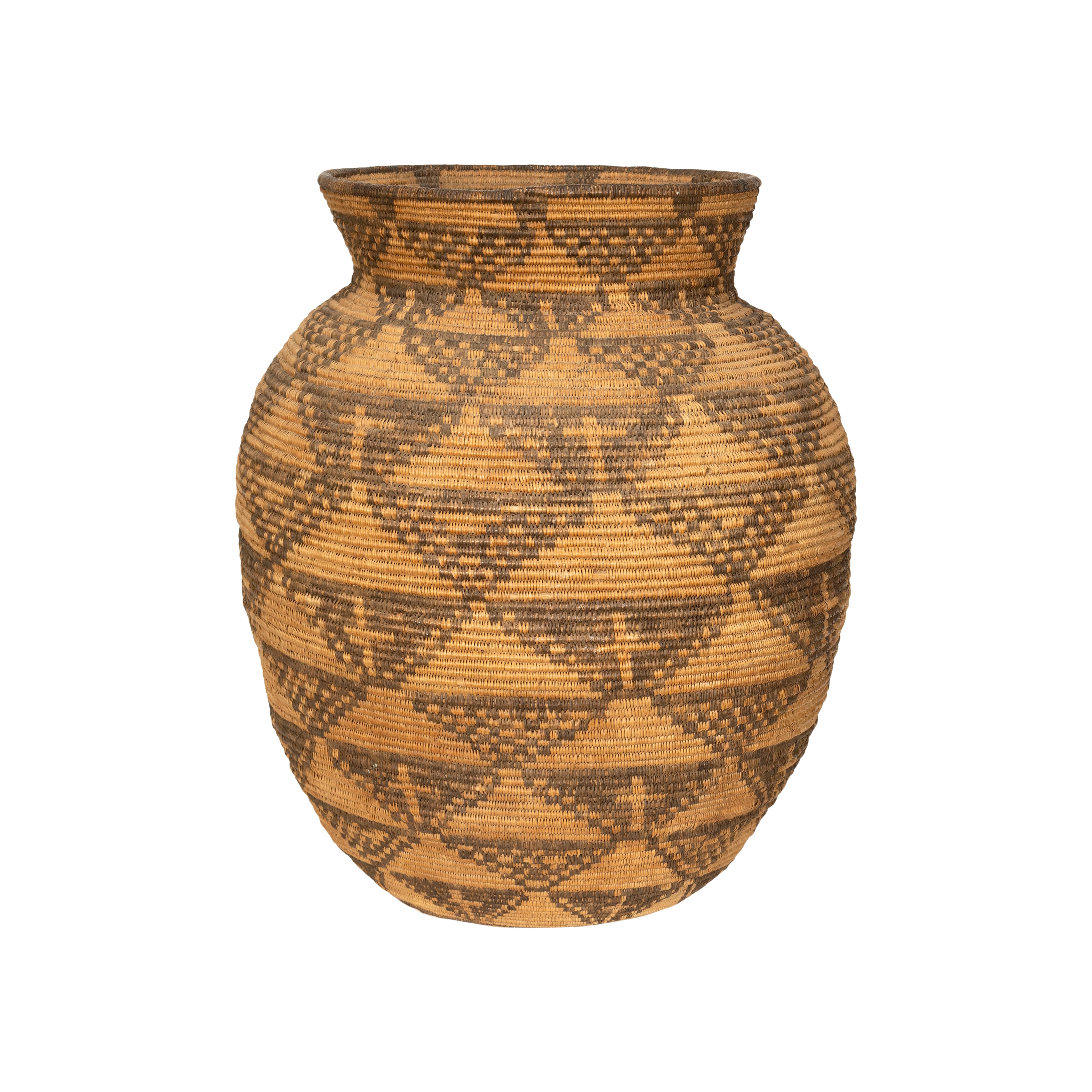 Figurative Apache olla with crosses made inside, vertical triangles that connect in a geometric web. After an olla was filled to the brim with wild grass seeds such as chia or amaranth, or domestic plant products like corn or beans, a basketry lid