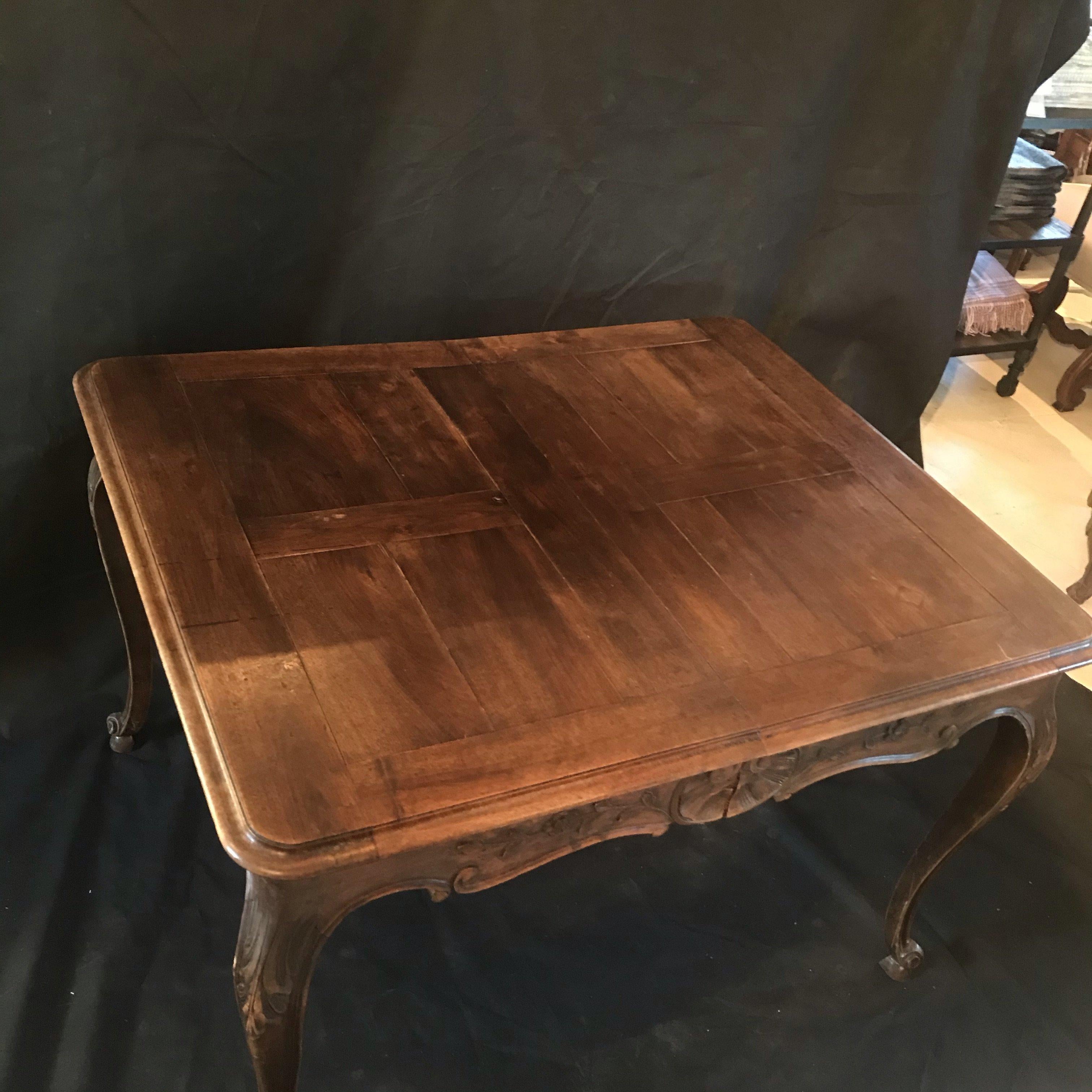 Beautiful 19th century country French Louis XV carved walnut dining table. Can also be used as a large desk or game table. Gorgeous banded parquet table top. No leaves included.
Measures: H skirt 22.5”
#1903.