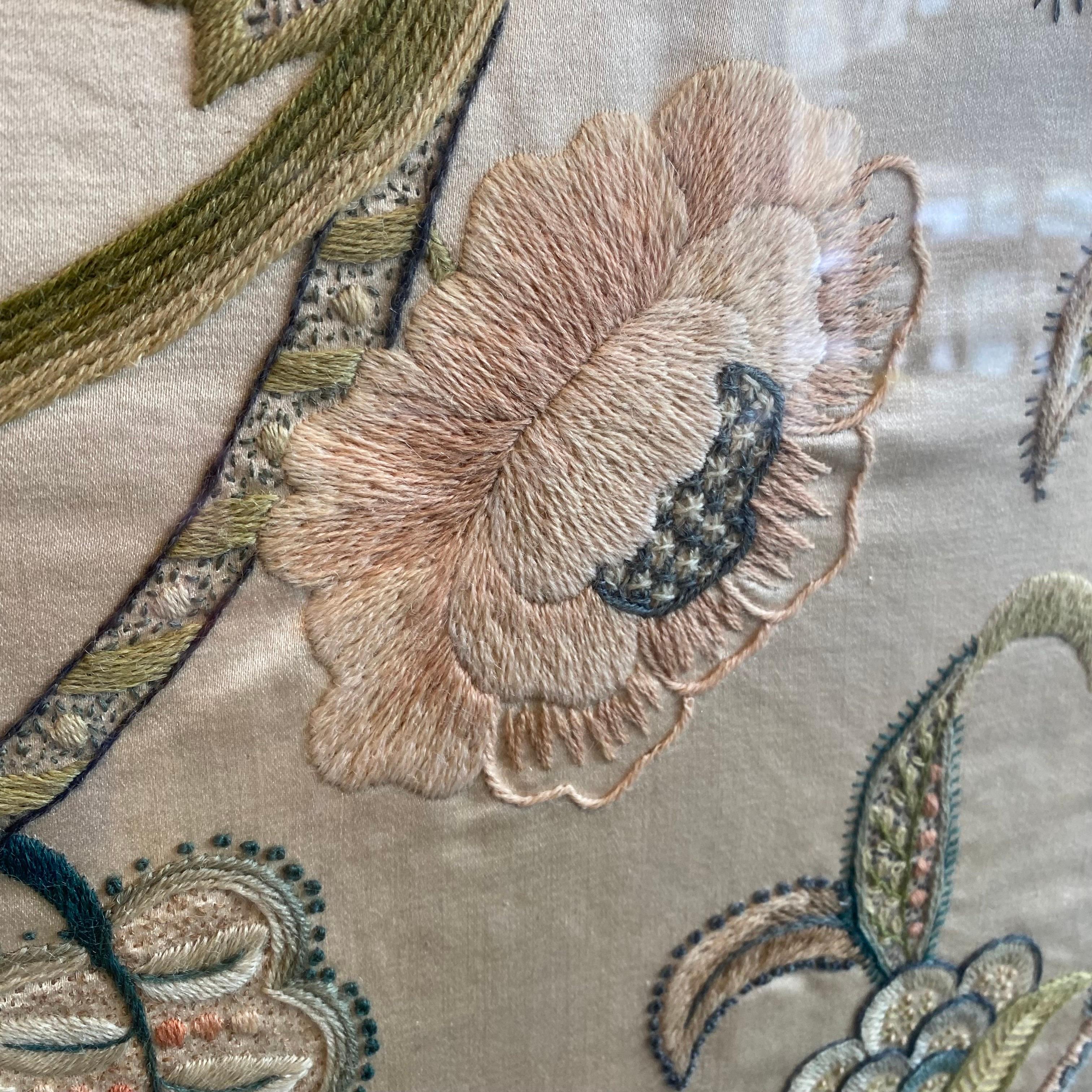 A very nice example of a 19th century antique woollen crewel work on a silk ground. Glazed and framed in light oak. 

Unsure of specific age or origin.