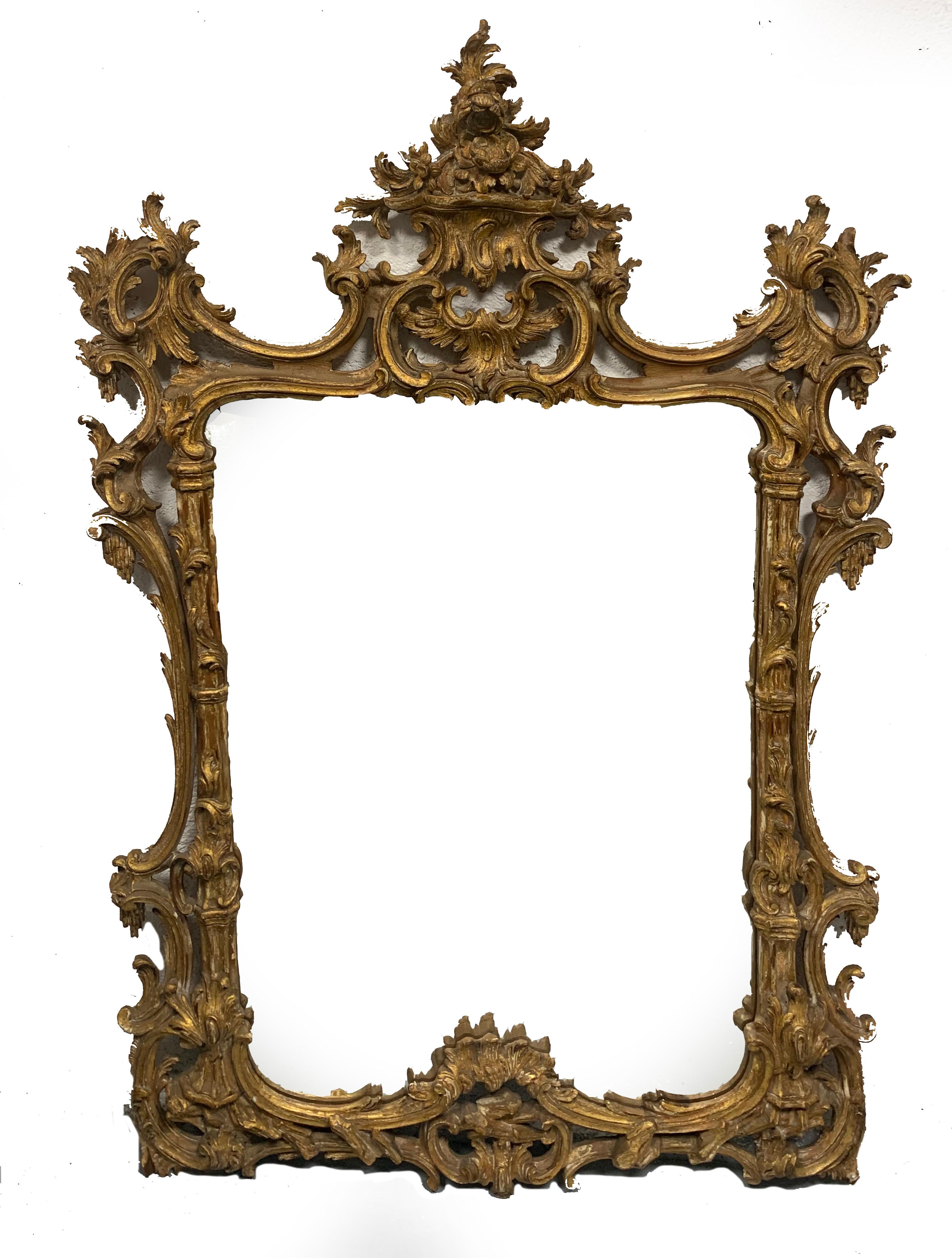 Beautiful wood carved golden mirror with delicate and robust openwork carving throughout. The warm gilt wood surface of this mirror is exceptional.