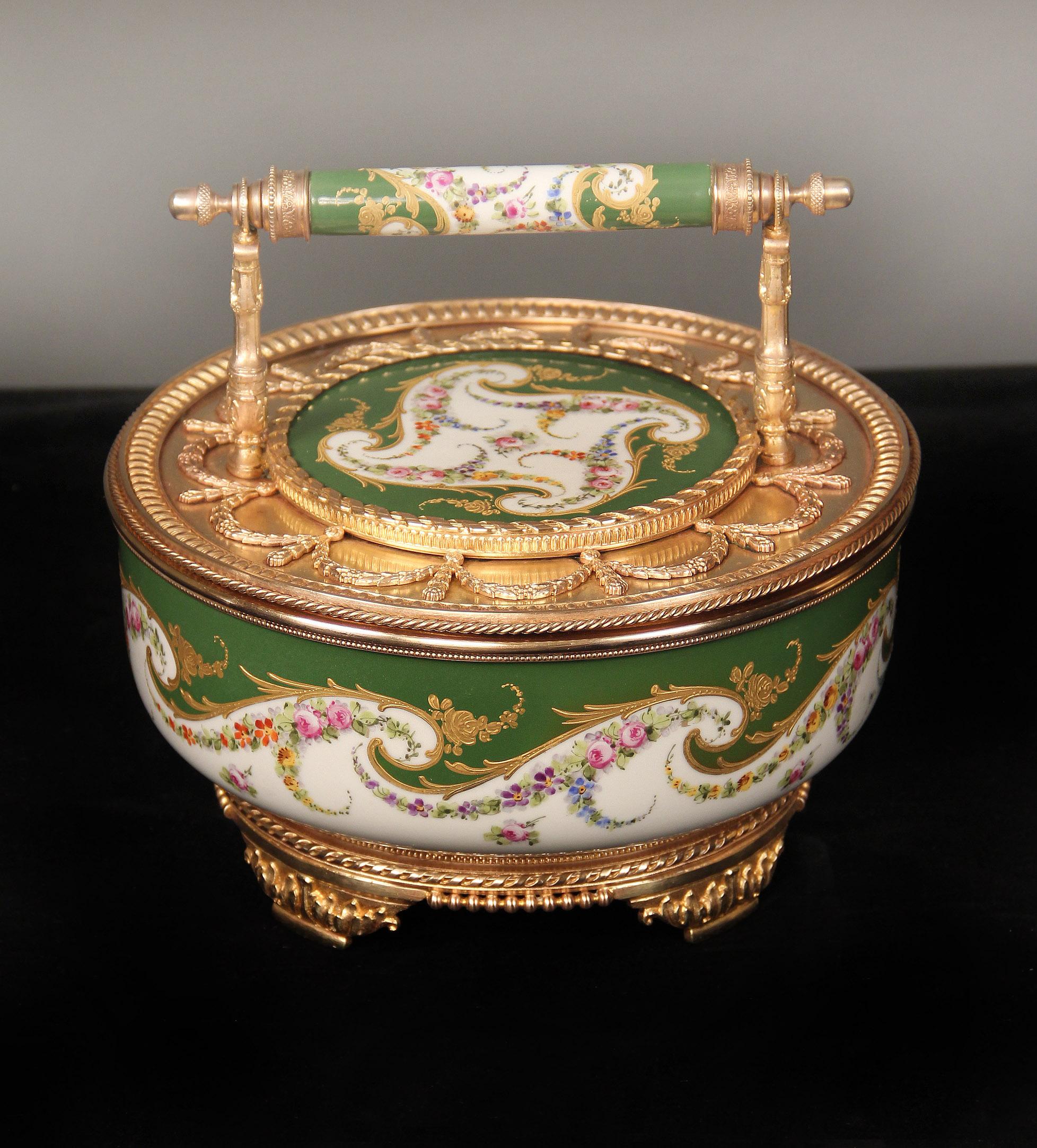 A beautiful late 19th century gilt bronze-mounted sèvres style porcelain candy dish

The green and white porcelain bowl painted with colorful flowers and with raised gilt designs, the cover and handle with similar porcelain designs.

In late