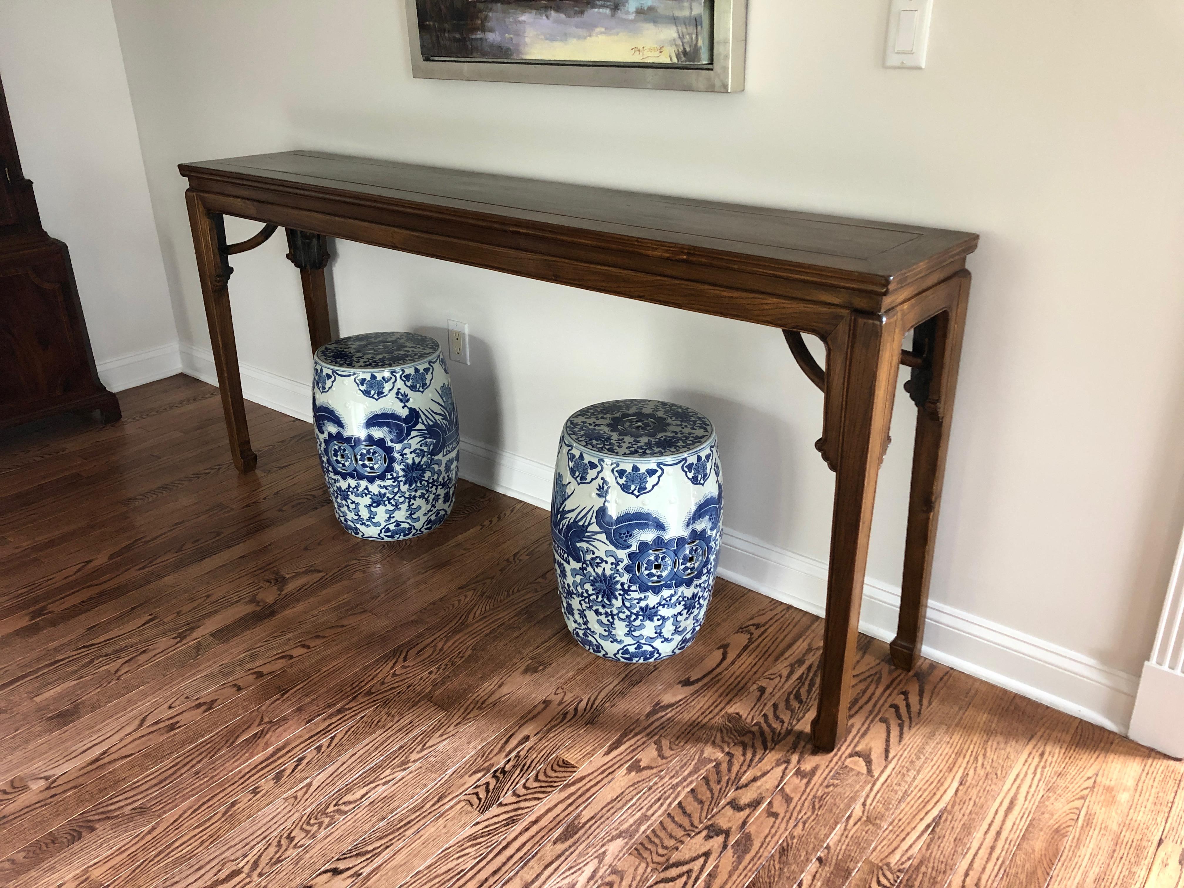 Elegant long narrow hardwood Asian console having beautiful grain, brass decorative supports and stunning classically shaped Chinese legs. Comes with Certificate of Authenticity from Tomlinson, Singapore.