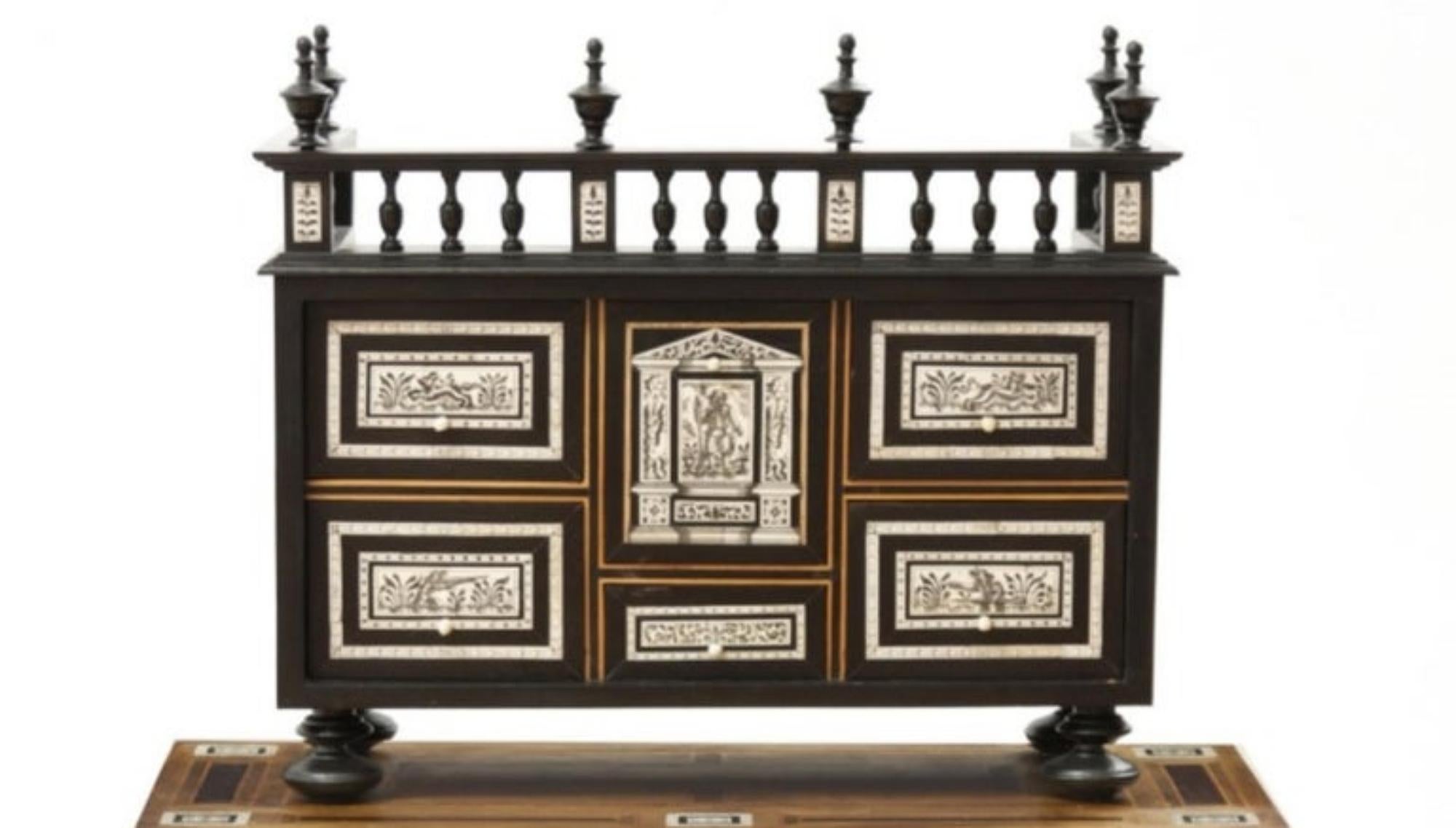 Spanish Bargueño with table in mahogany, walnut and ebonized wood with bone inlays representing different hunting scenes and animals on the central door. Interior with 4 drawers and finished off with a balustrade. Table with lentil legs and iron