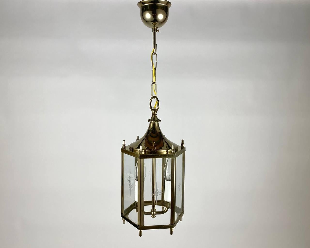 Vintage handcrafted chandelier- lantern for two light points made in 1970s-1980s. 

A chandelier from manufacturer is an amazing combination of warranty from the manufacturer and the design of the lighting fixture.

The hexagonal shade comes