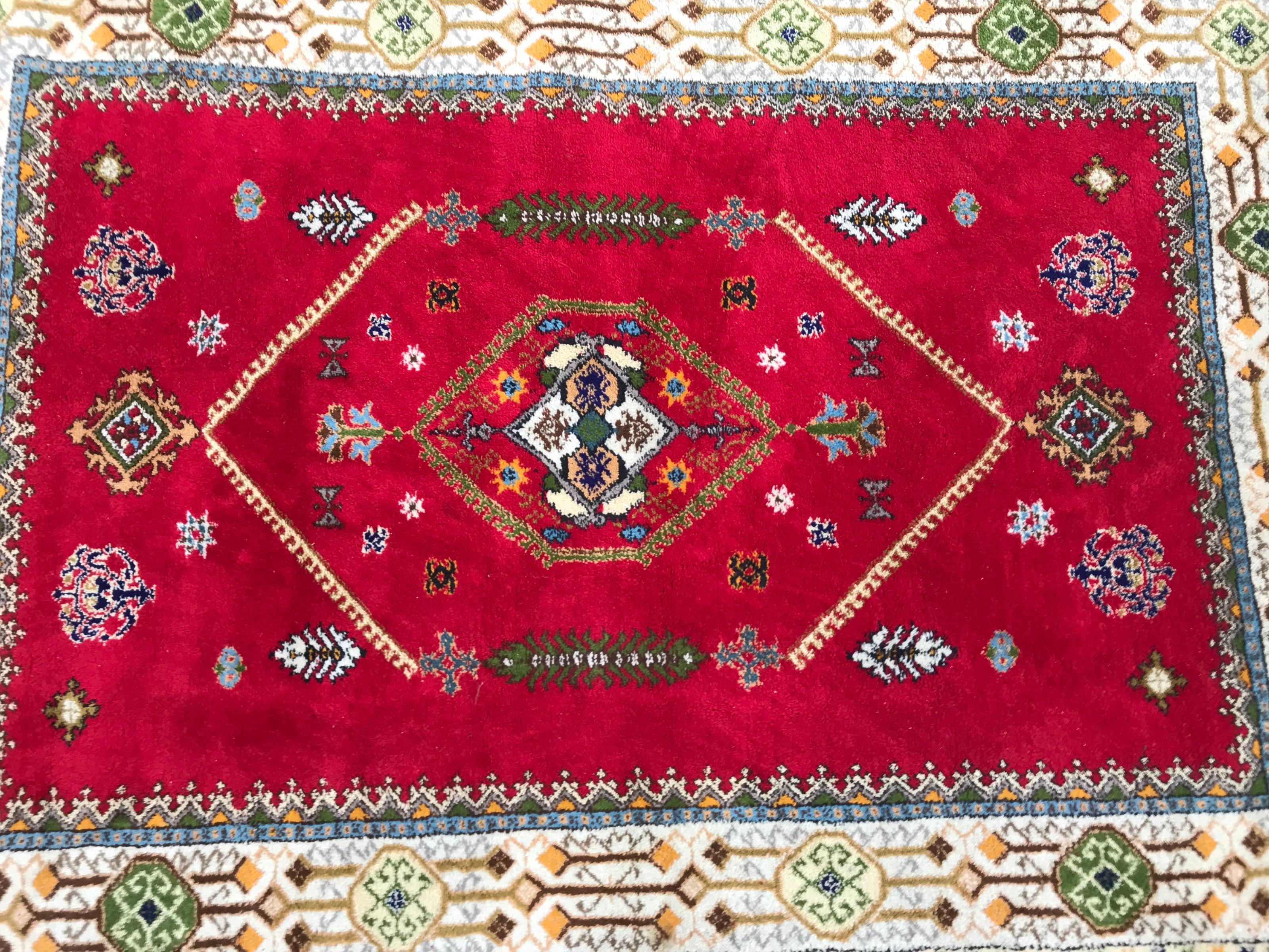 Nice vintage Rabat rug with beautiful geometrical design and red field with green, blue, orange and yellow, entirely hand knotted with wool velvet on wool foundation.