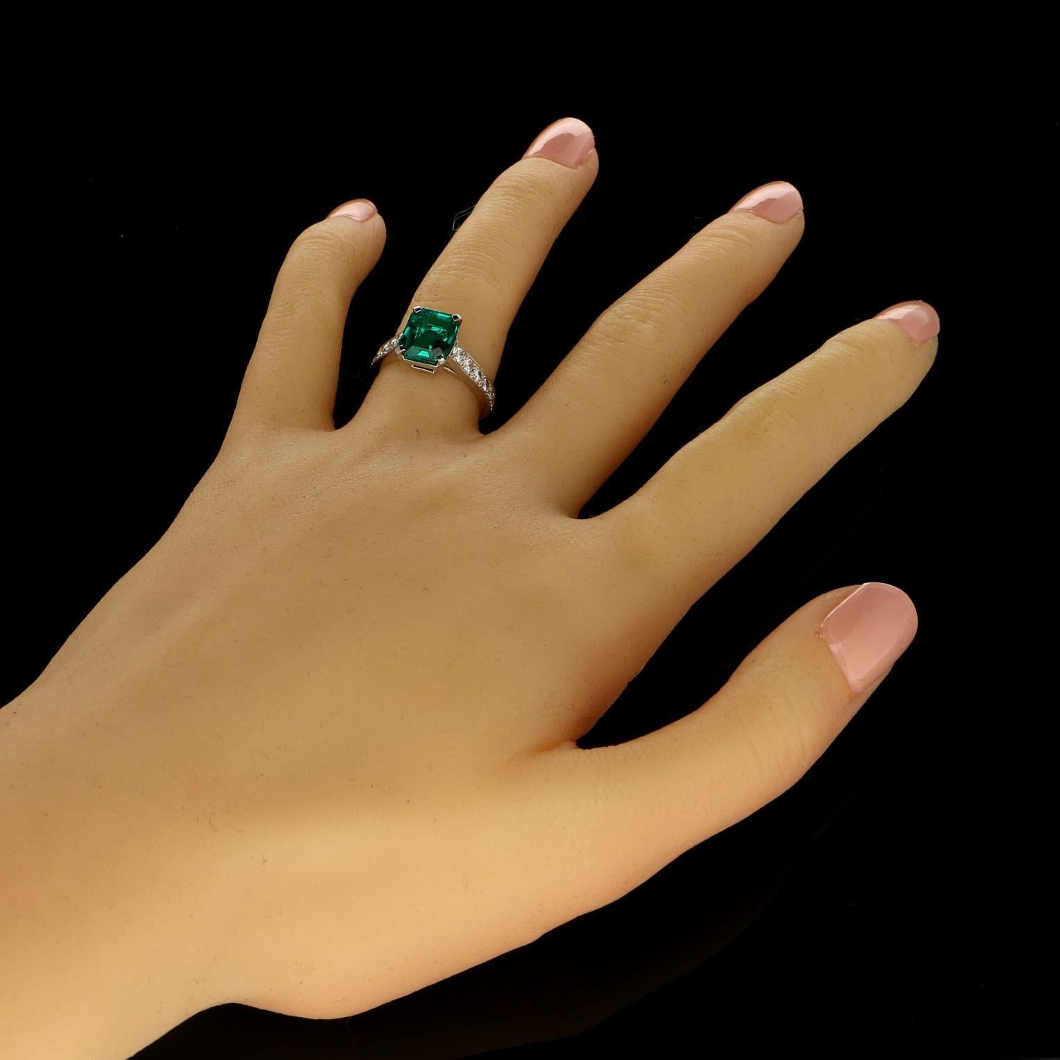 A beautiful  completely untreated no oil emerald and diamond ring by Cartier 2006, centred with a wonderful Colombian emerald-cut emerald weighing 2.59cts claw set between tapering shoulders set with graduated round brilliant cut diamonds, all in a
