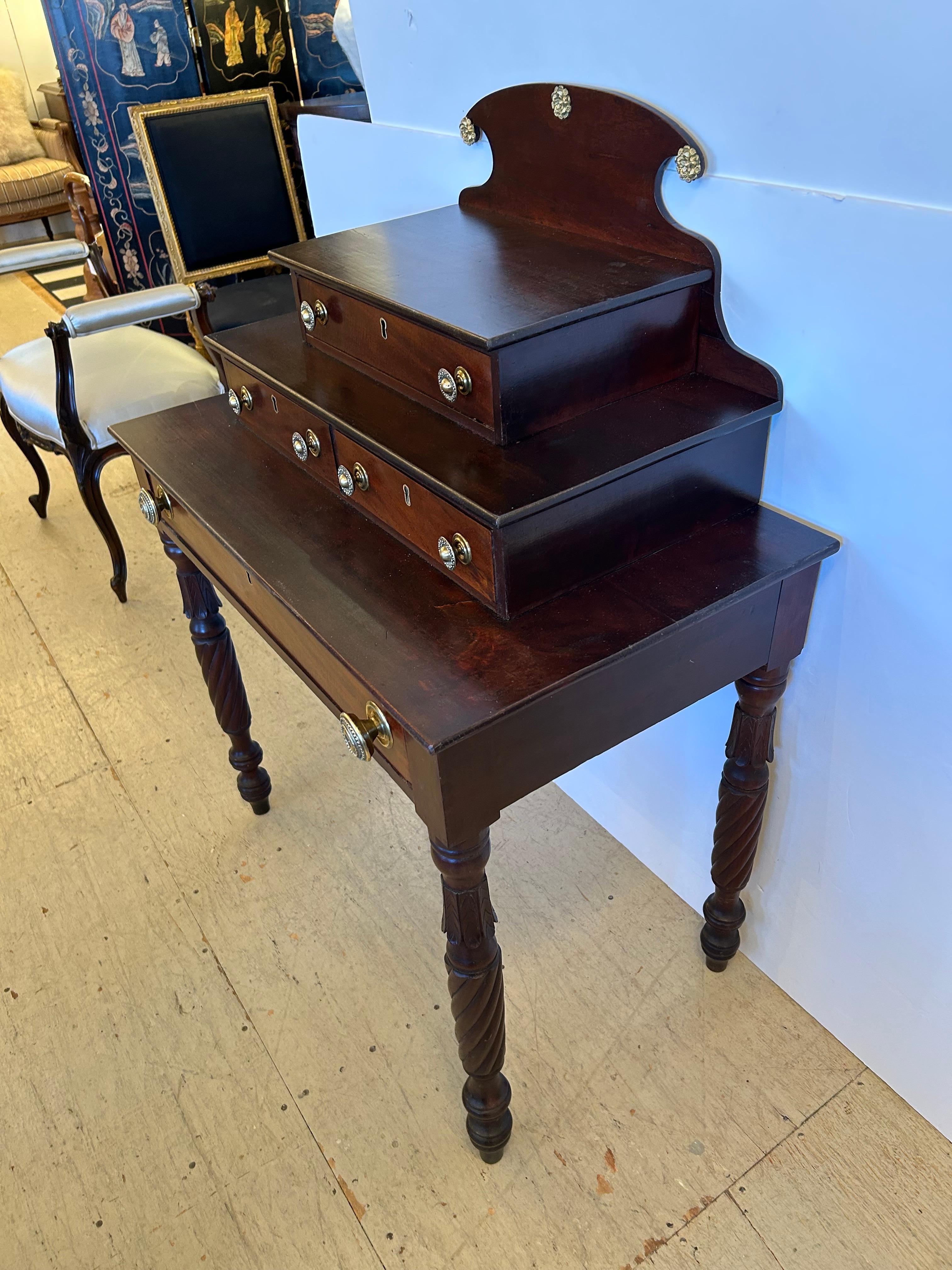Beautiful and unusual 3 tier vanity table having 5 drawers, gorgeous carved wood turned legs, and lovely original brass hardware and florets.
No key included.

28” h to 1st level
4.5” from first level to 2nd tier
4.25” from middle to top level