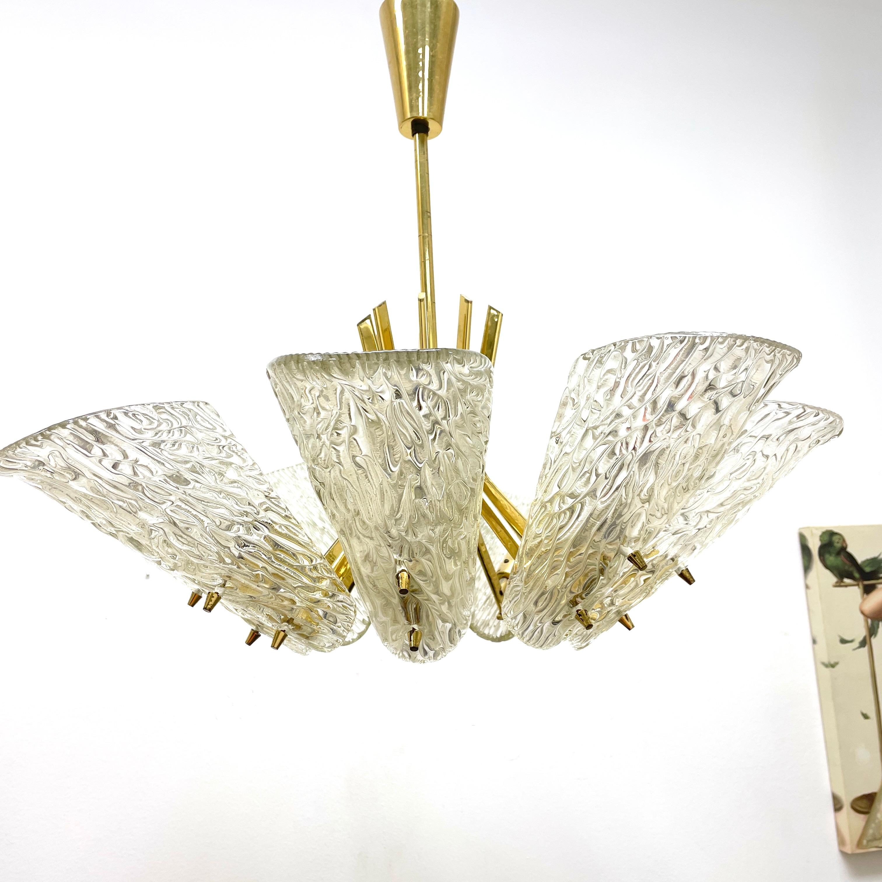 Beautiful and rare chandelier or pendant light by Kalmar Vienna, Austria. An original mid-century vintage piece manufactured in the 1950s. It is made of brass and heavy glass. The fixture requires nine European E14 / 110 Volt Candelabra bulbs, each