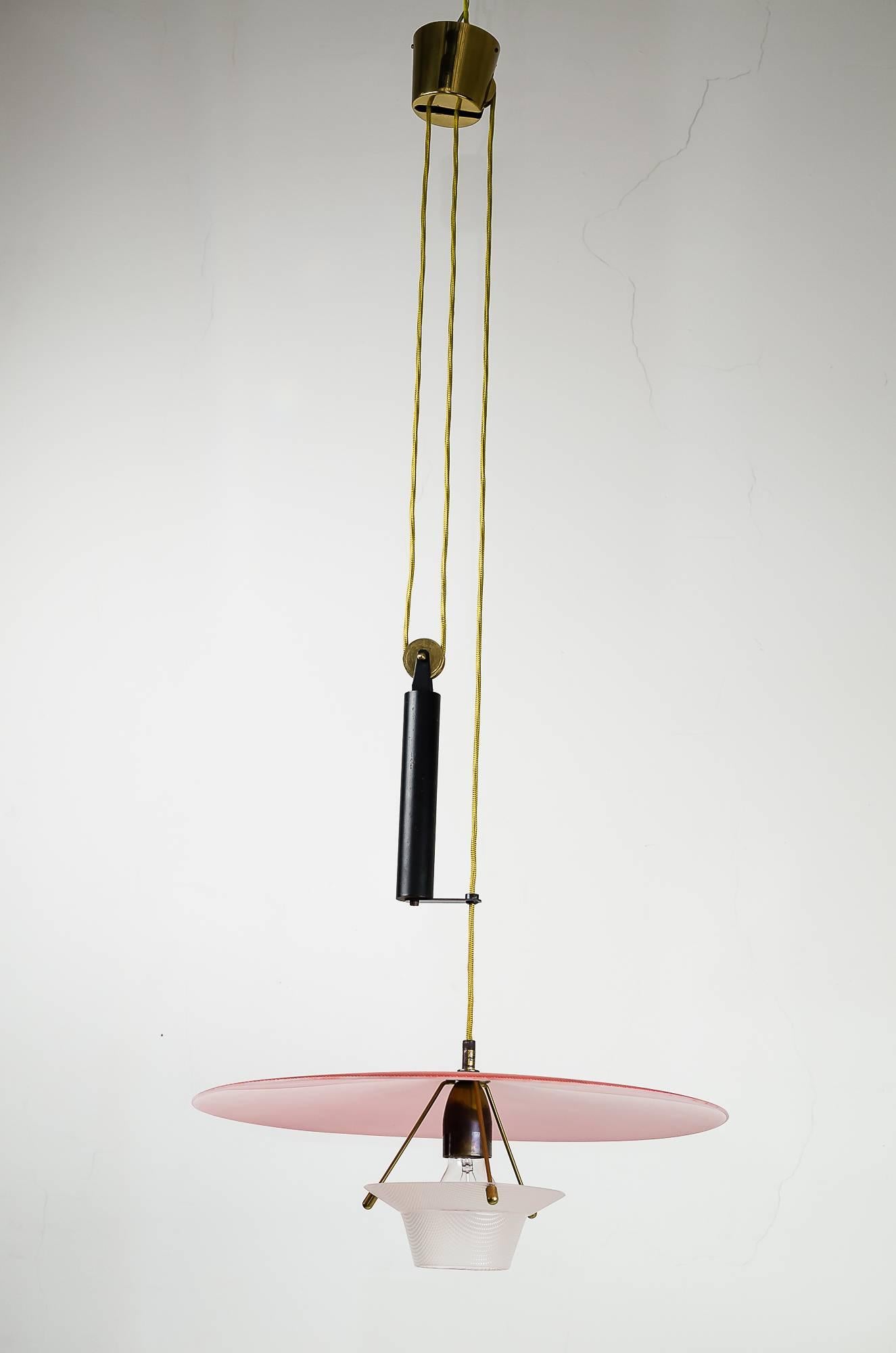 Italian modernist.
Attributed Arredoluce.
Very nice shaped chandelier with typical 1960s red color shade.
Shade adjustable in height using the counter weight.
Red Lucite shade, black lacquered metal.
Measures: Diameter shade 19 inch