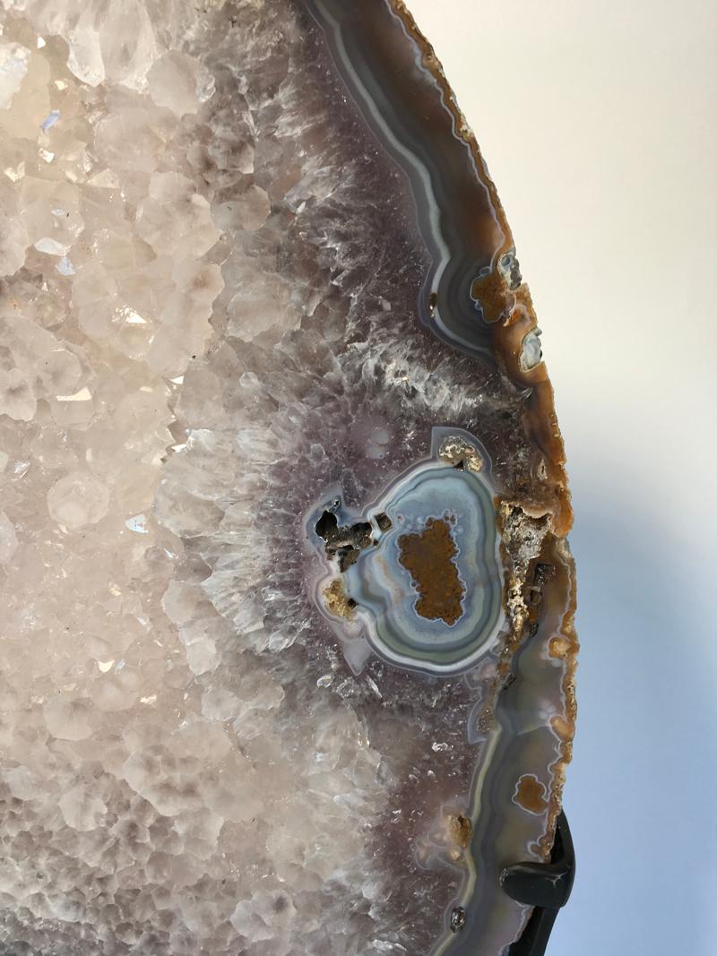 Shades of grey, rust, brown and crystalline white make this beautiful agate slice on a custom mount a stunning piece.
Agate has long believed to promote protection, strength and harmony.
The dimensions of the agate are 35 cm x 45 cm x thickness 3