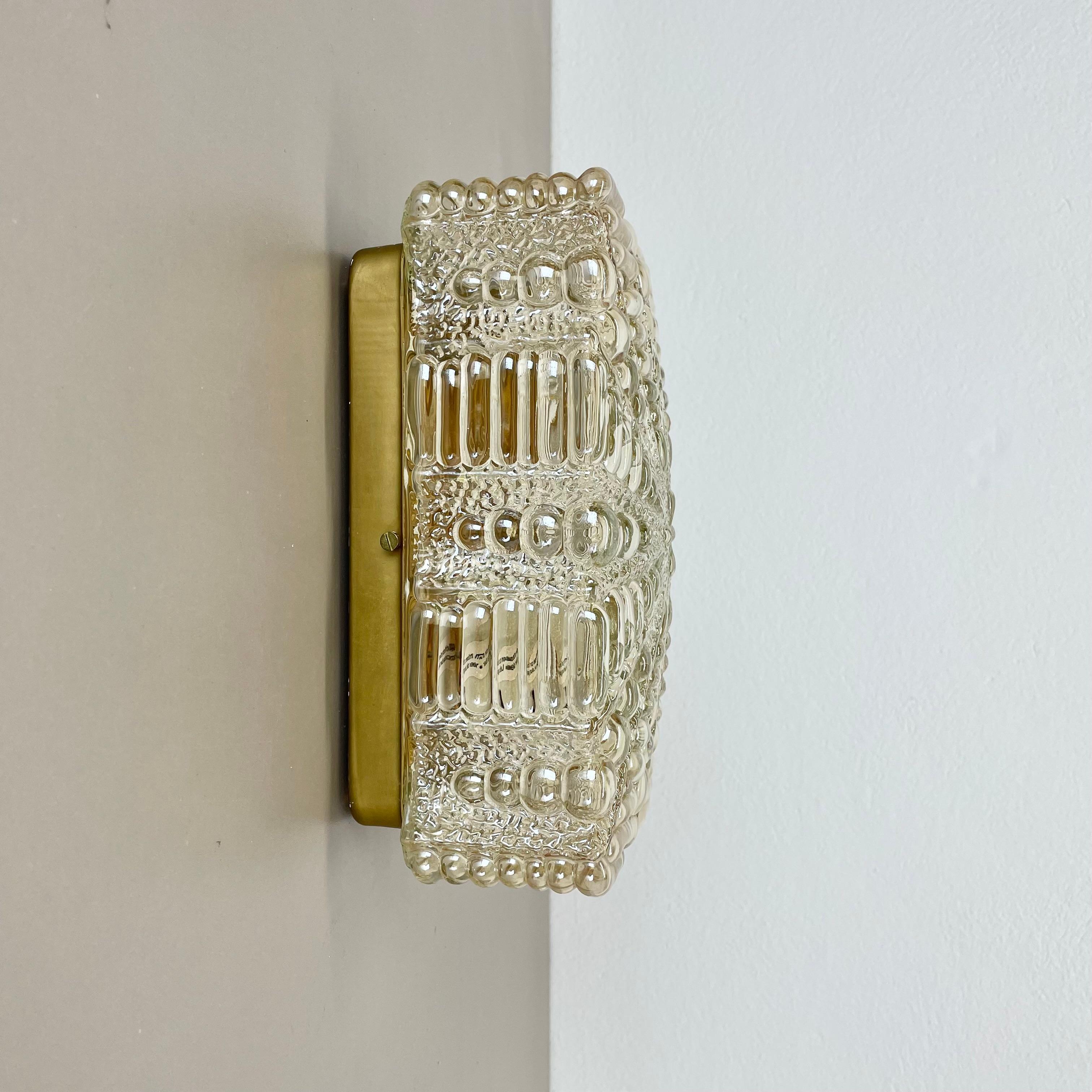 Article:

Wall light sconce


Origin:

Germany


Producer:

RZB LIGHTS (see label inside the light)


Age:

1970s



This original modernist wall light was produced in Germany in the 1970s. It is made from heavy glass and has a metal wall fixation.