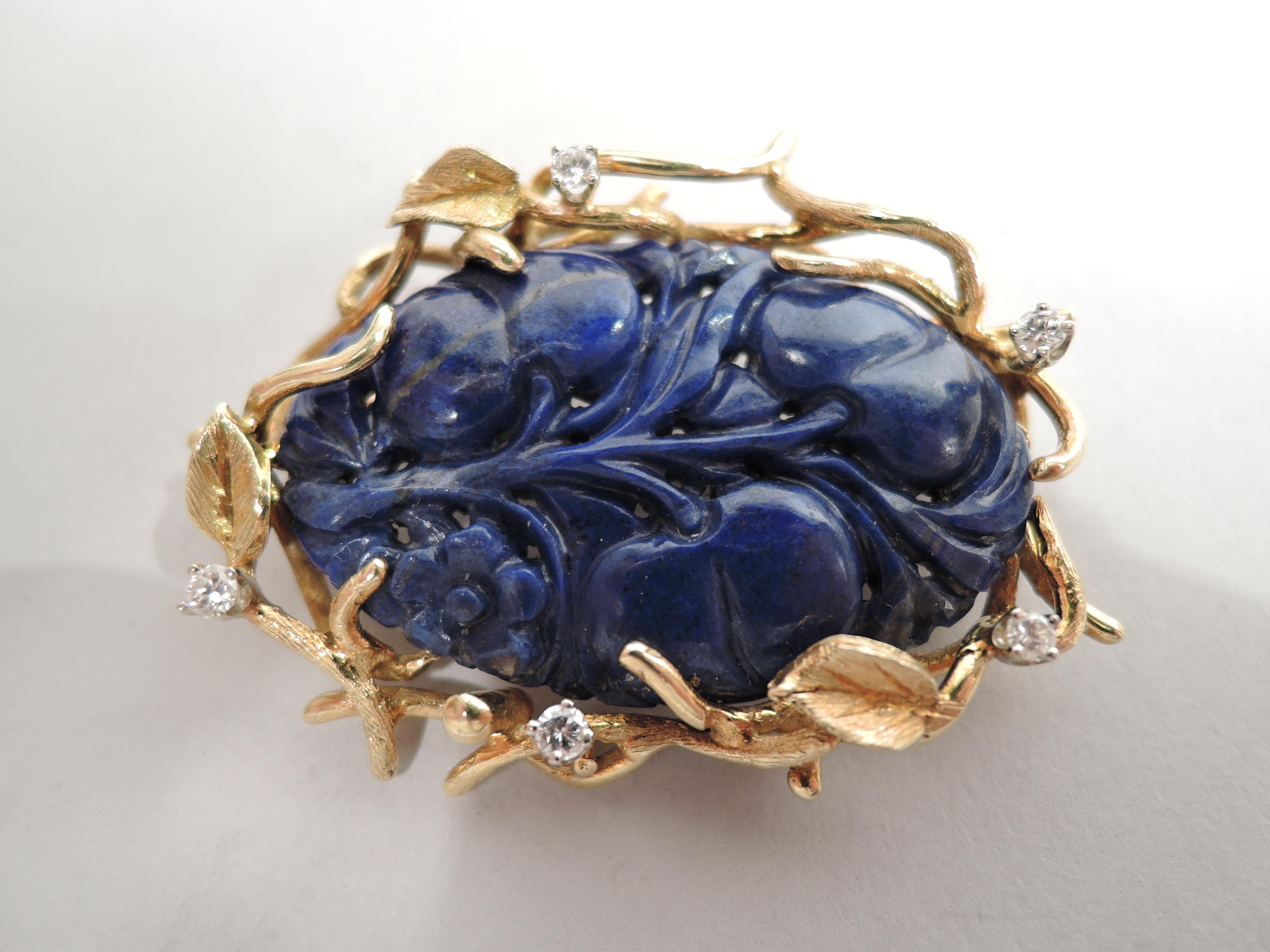 Beautiful Midcentury Modern brooch. Carved oval leaf and flower lapis in 18k yellow gold leaf-and-branch mount interspersed with five diamonds. United States, ca 1960s.