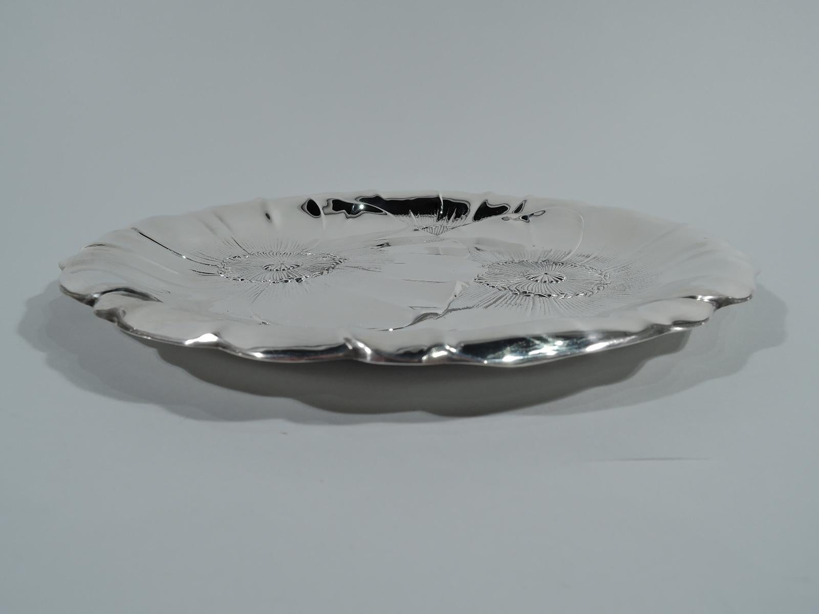 Beautiful modern sterling silver cake plate. Made by Wallace in Wallingford, Conn. Shallow with curved sides and irregular petal rim. Chased and engraved floral ornament in form of big overlapping blossoms. Hallmark includes no. 123. Weight: 11.9