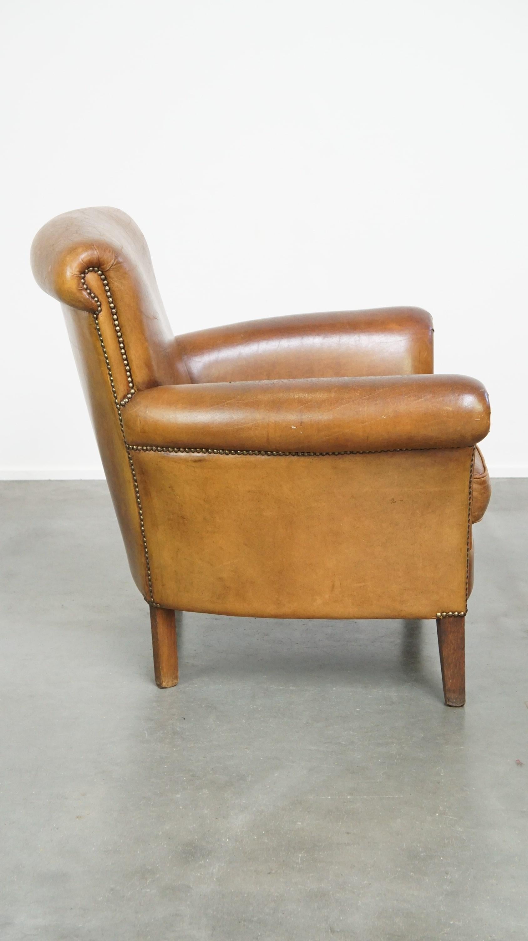 Hand-Crafted Beautiful and comfortable sheepskin armchair, finished with decorative nailheads For Sale