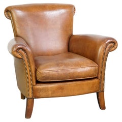 Beautiful and comfortable sheepskin armchair, finished with decorative nailheads