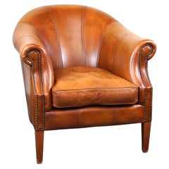 Beautiful and high-quality cowhide leather club armchair in cognac color